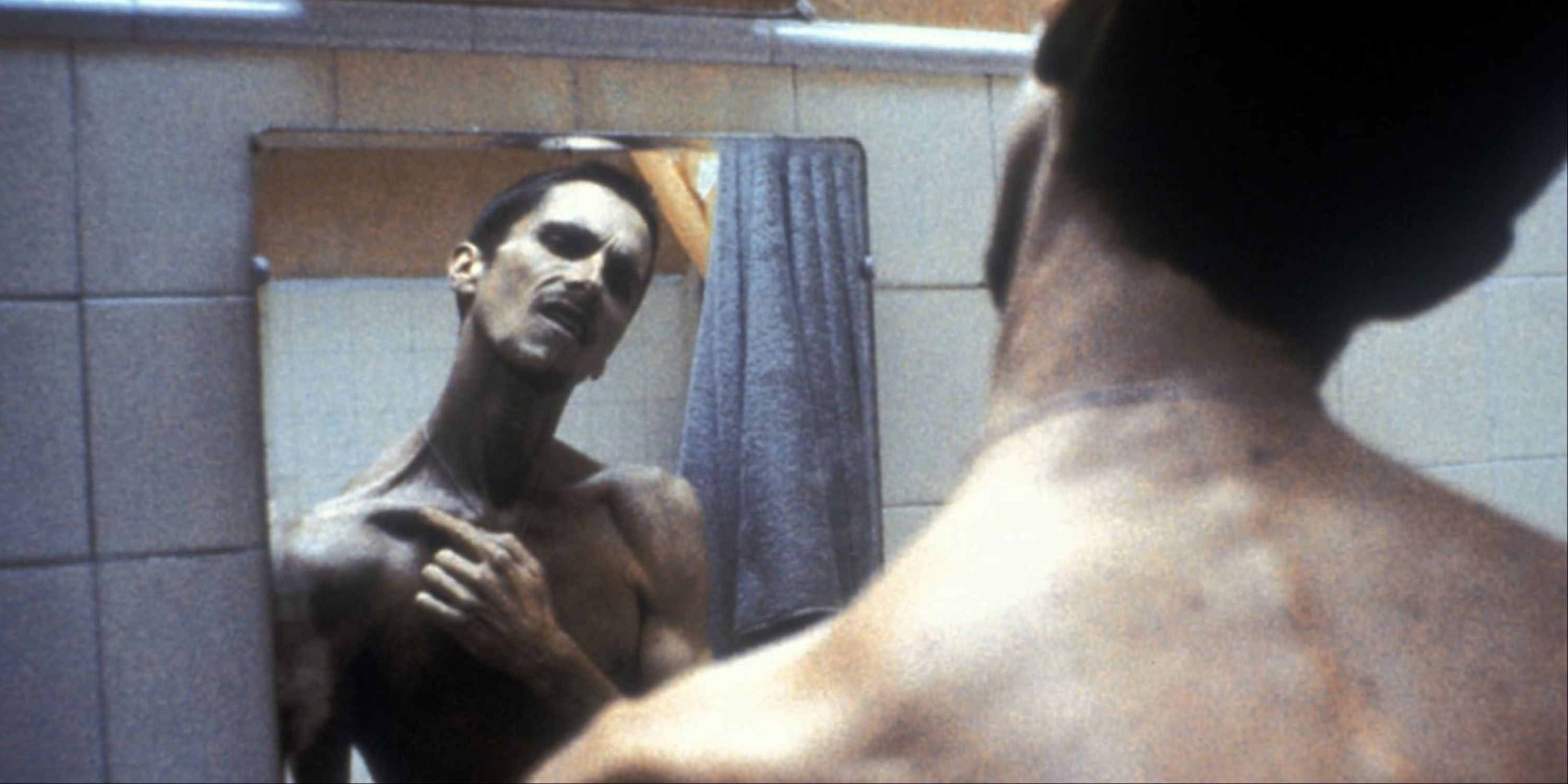 A gaunt Christian Bale looking at himself in the mirror in The Machinist.