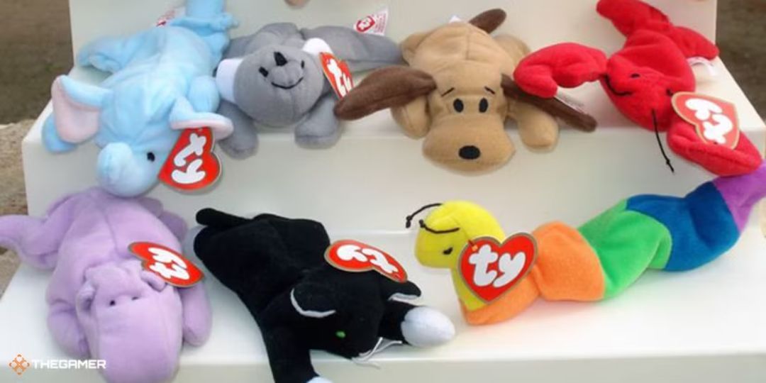 A group of Beanie Babies sit on a table.