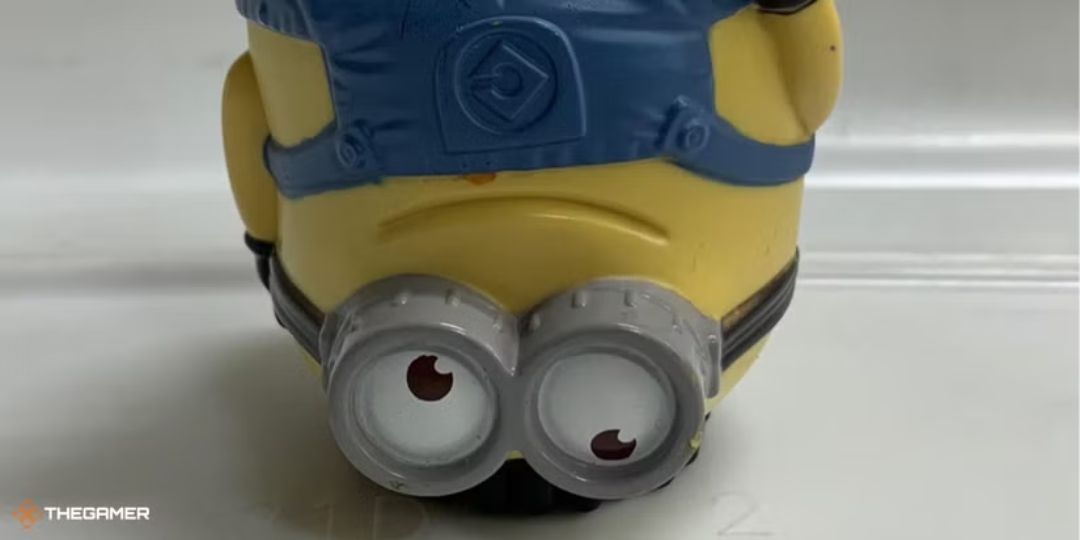 A Minion toy stands upside down.