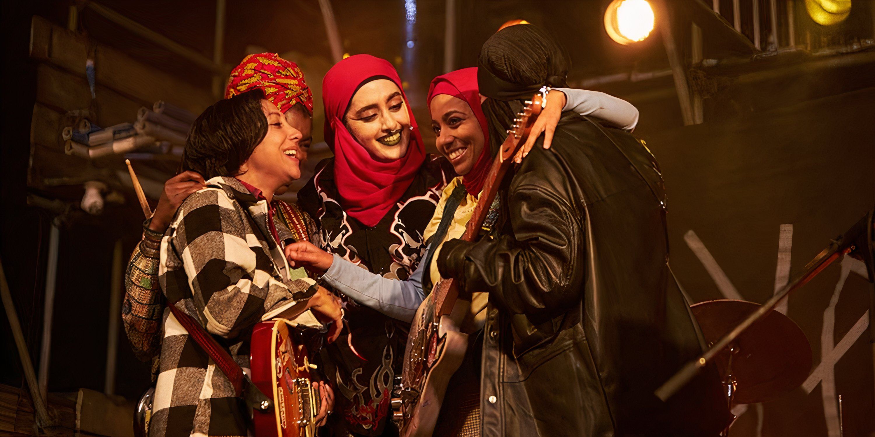 Amina, Saira, Bisma, Momtaz, and Ayesha embrace after a succesful gig in We Are Lady Parts.