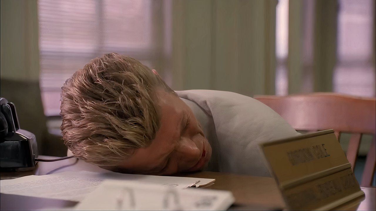 David Bowie resting his head on a table in Twin Peaks Fire Walk With Me.