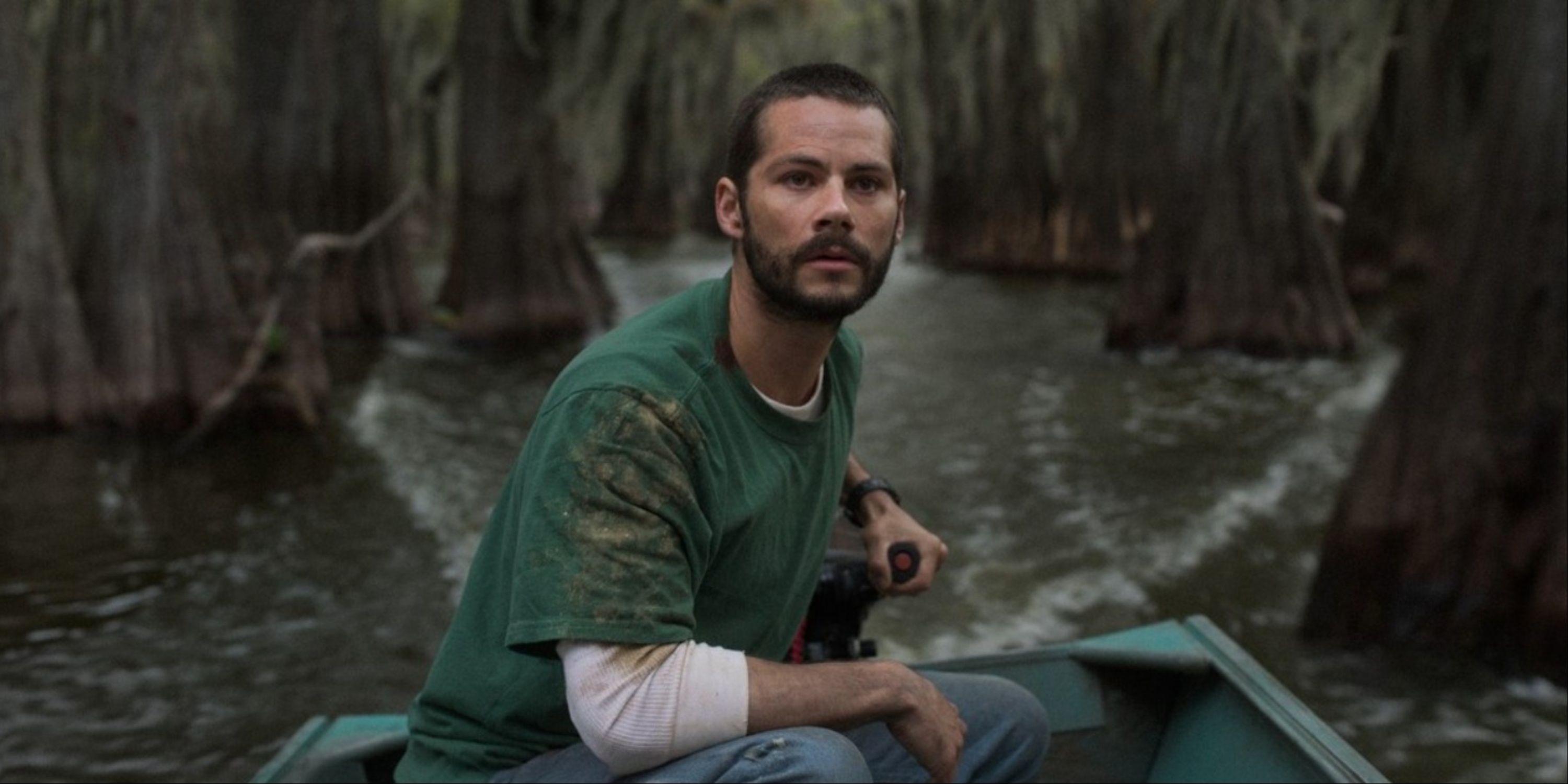 Dylan O'Brien steering a boat in Caddo Lake.