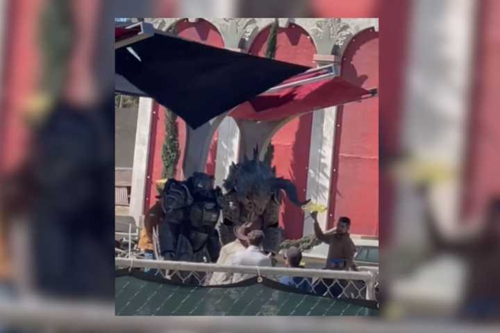 A leak from the set of the Fallout TV show, showing someone in power armour, and a deathclaw