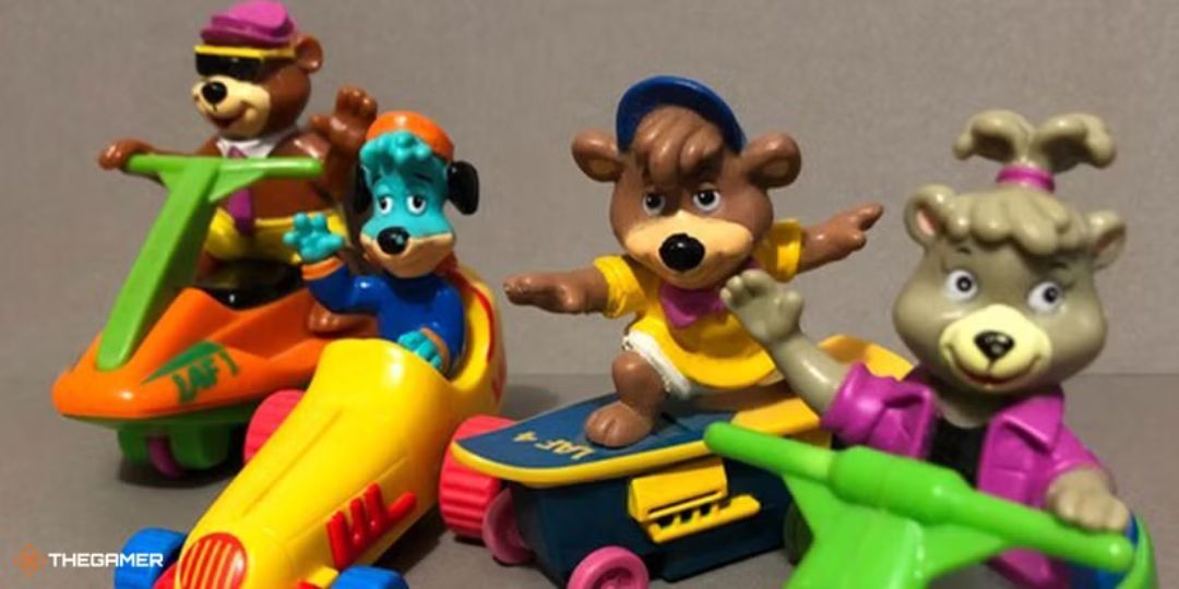 Four Yogi Bear toy characters sit in race cars.