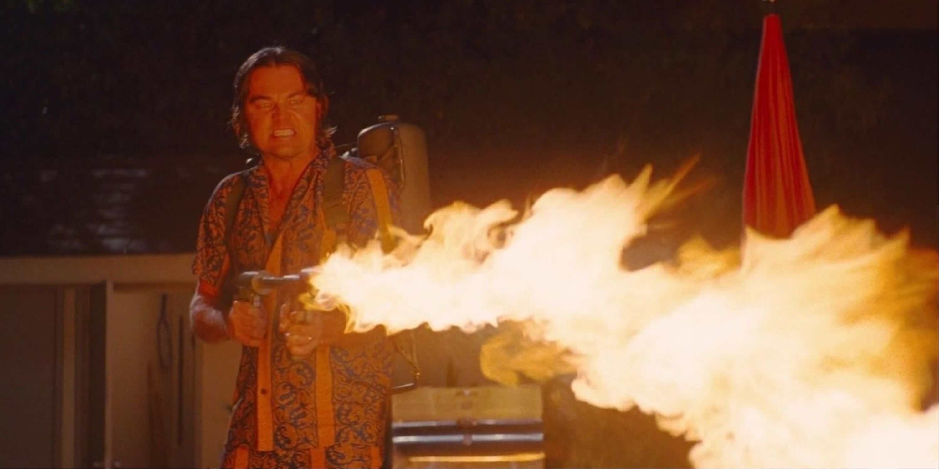 Leonardo DiCaprio as Rick Dalton using his flamethrower at a Manson follower in the pool in Once Upon a Time.. in Hollywood.