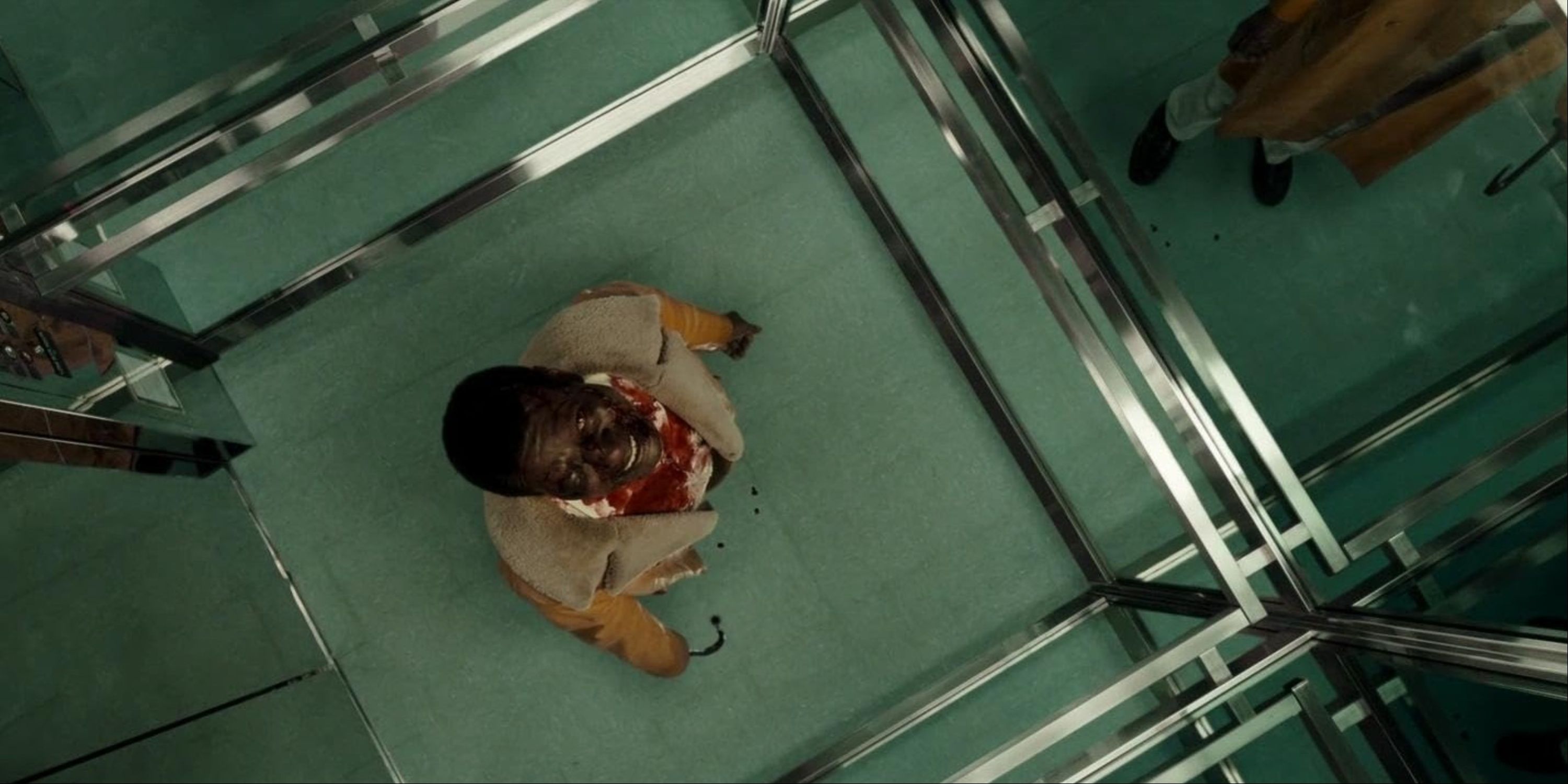 Michael Hargrove as the Candyman in the middle of an elevator creepily looking up in Candyman (2021).