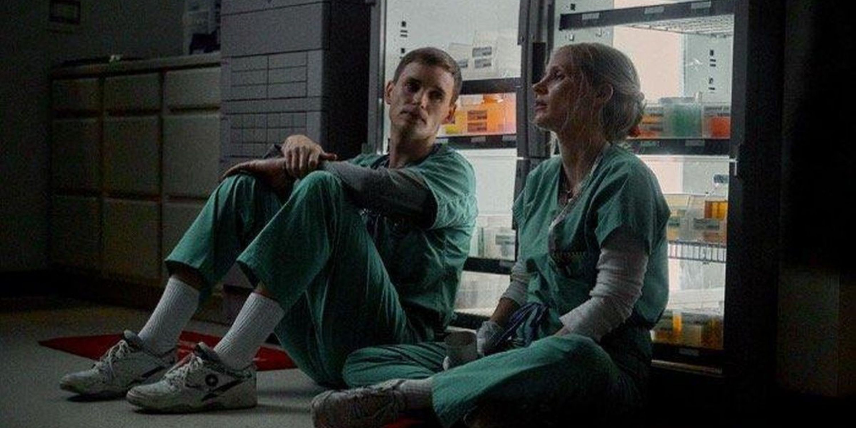 Charles and Amy sits on the floor and has a conversation in The Good Nurse.