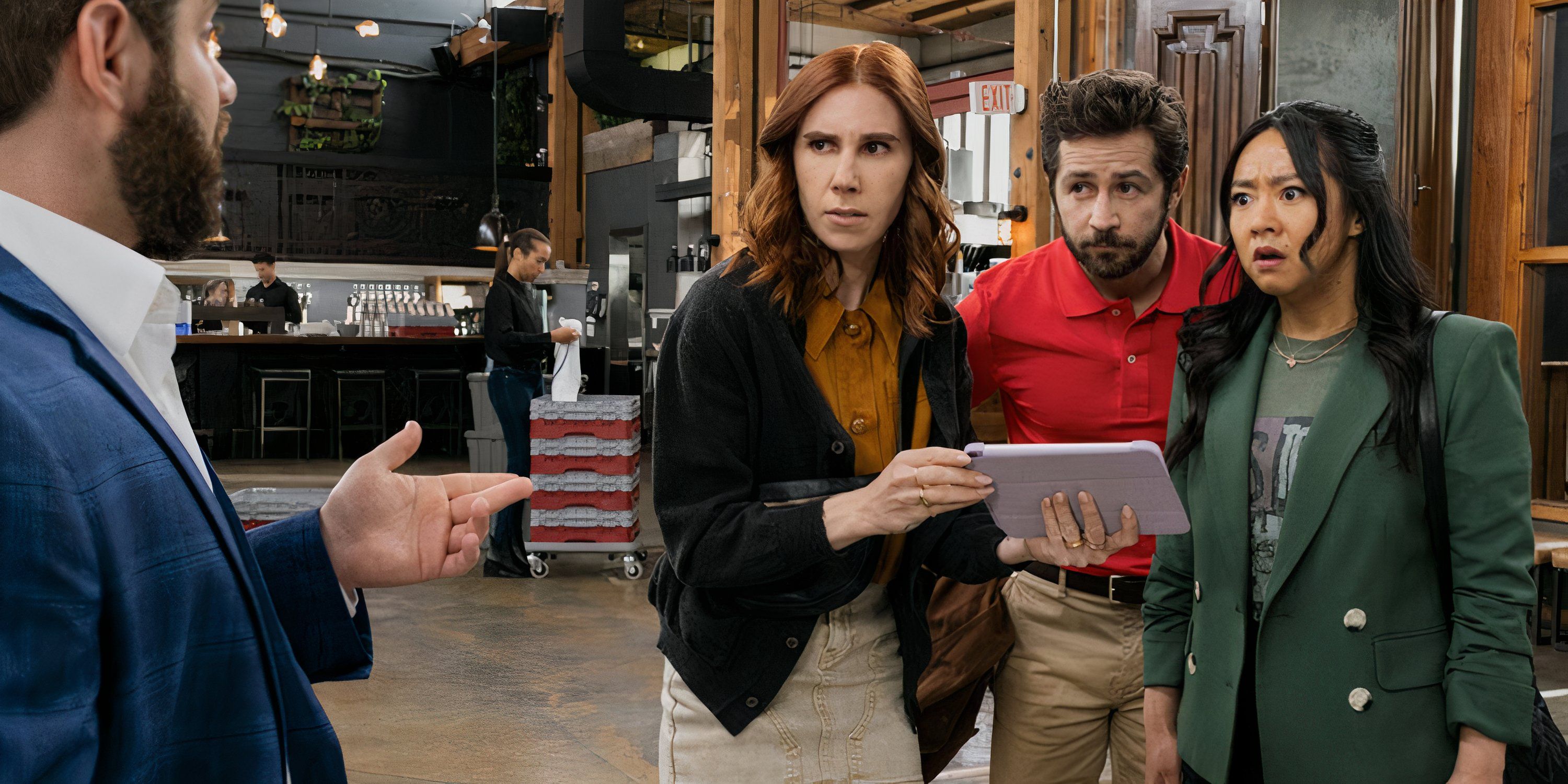 Ruby, AJ, and Richie look at a tablet in Laid.