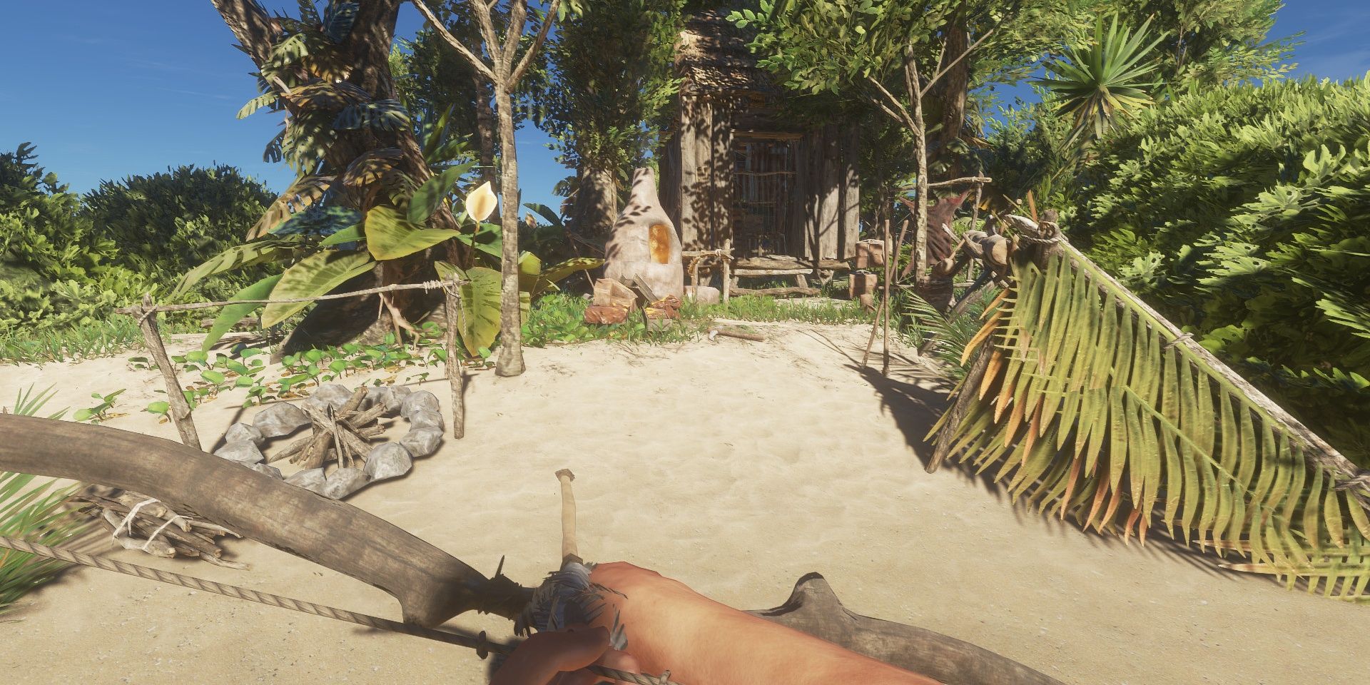 Stranded Deep: A survivor returning to their camp whilst holding a bow and arrow.