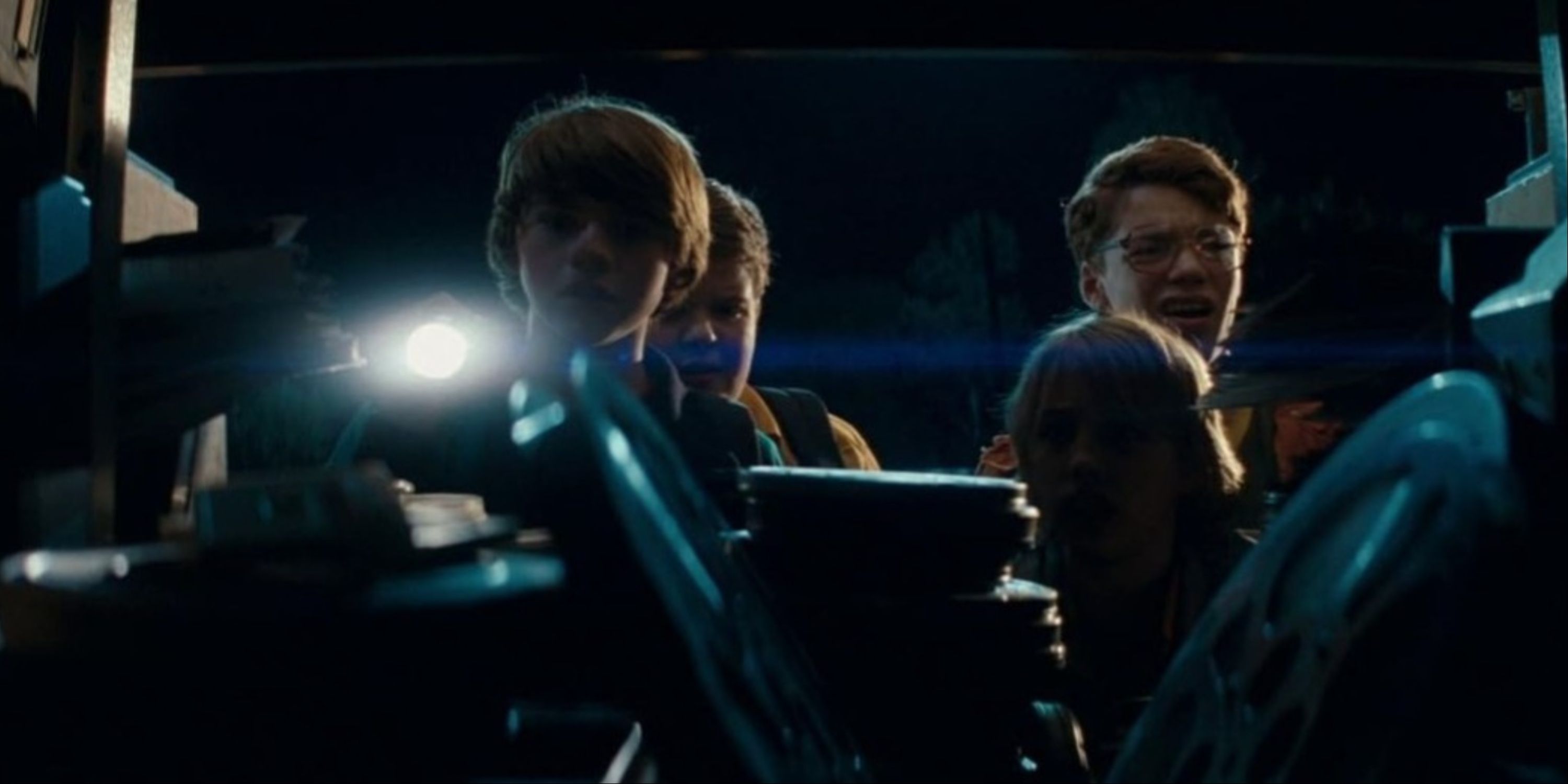 The main group of young boys looking at a pile of film reels at night in Super 8.