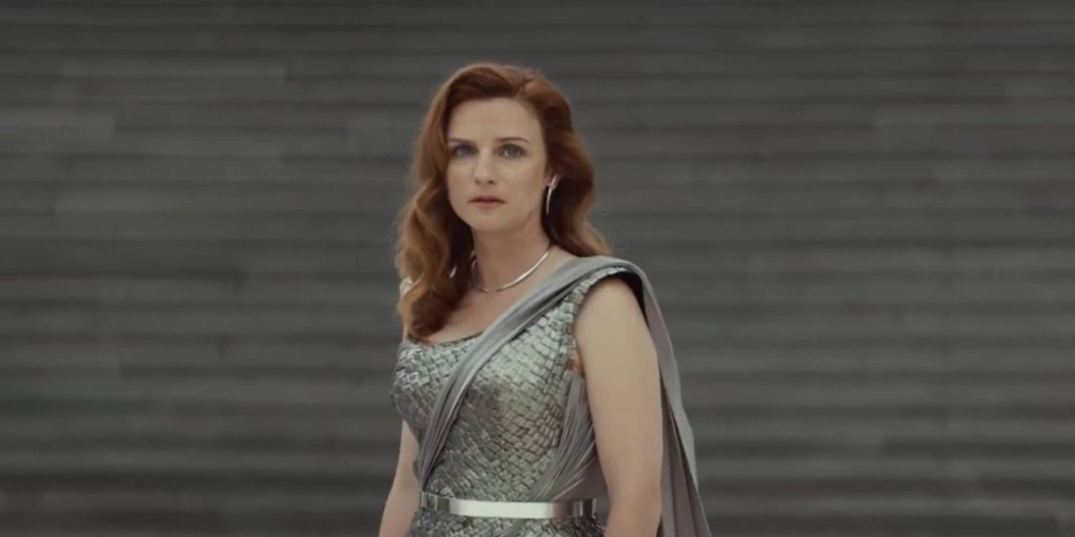 Vel Sartha in a formal dress looking worriedly at the camera in Star Wars: Andor.