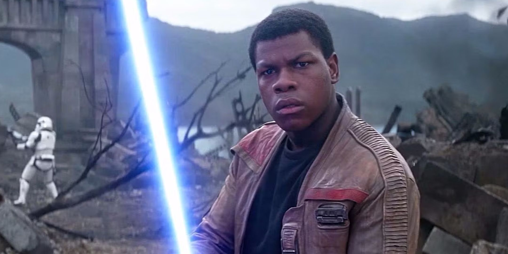 Finn wielding a lightsaber in Star Wars The Force Awakens.