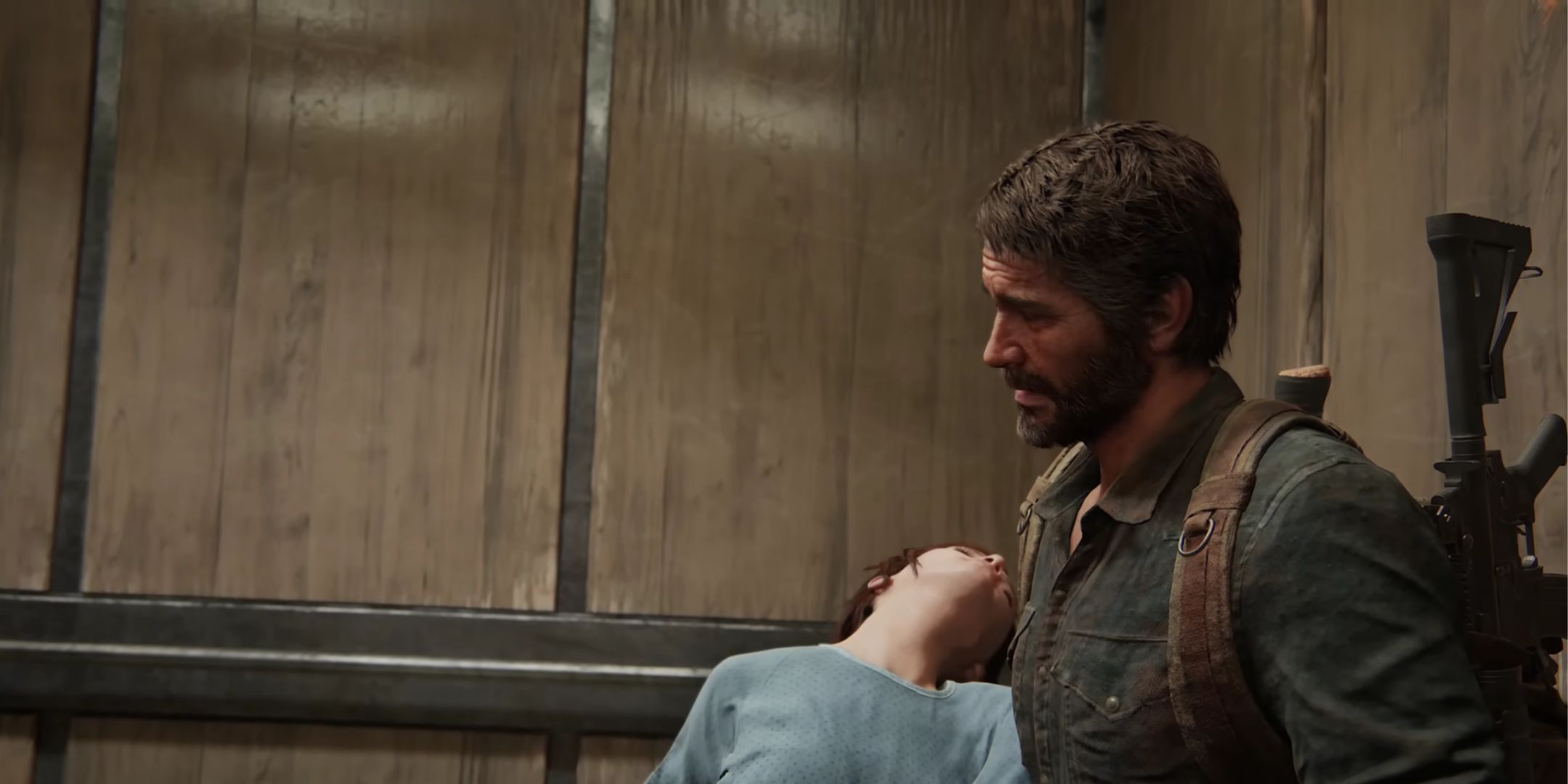 Joel holding Ellie in The Last of Us Part 1.