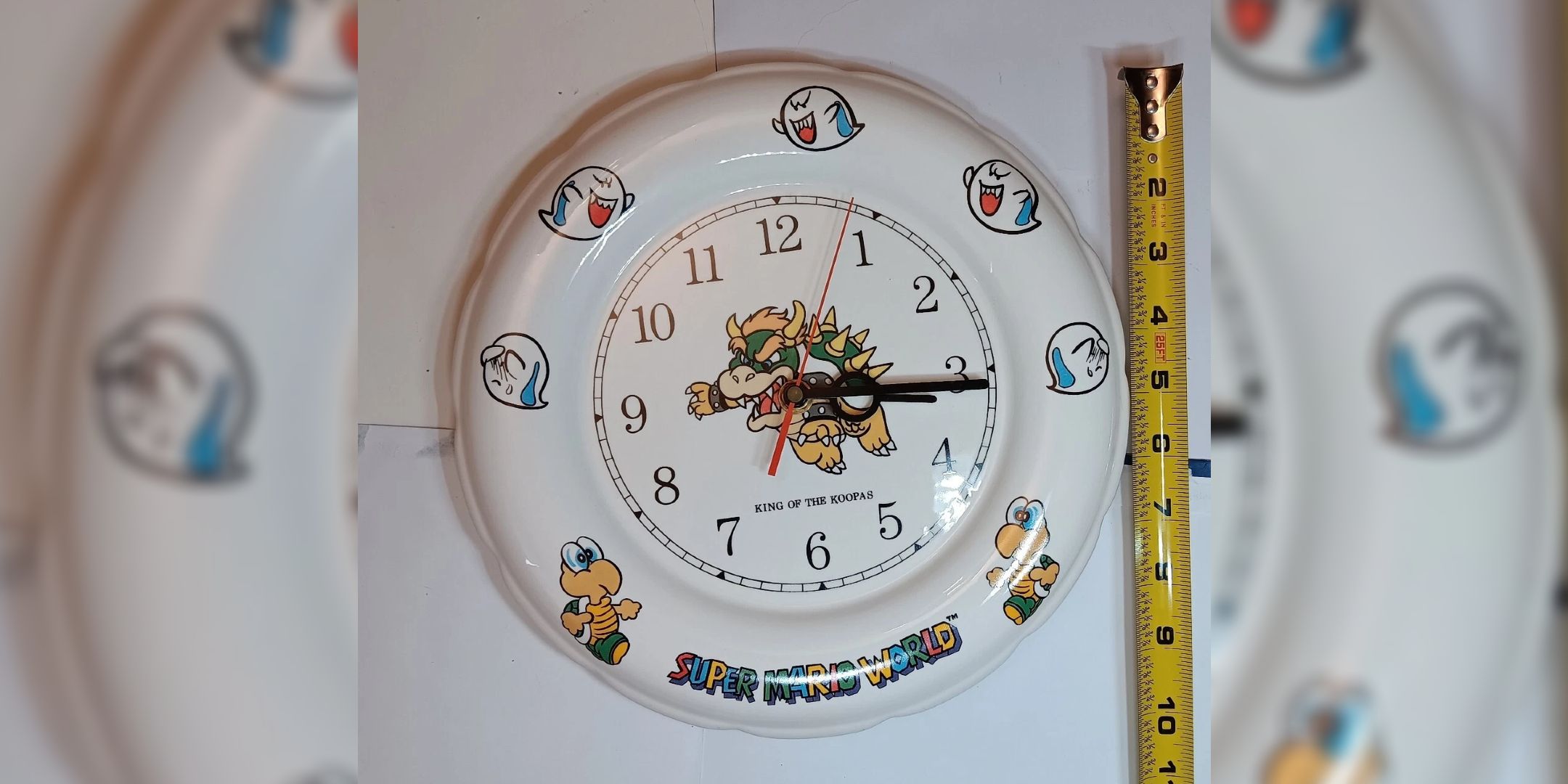 A close up of a 1993 ceramic Mario clock.