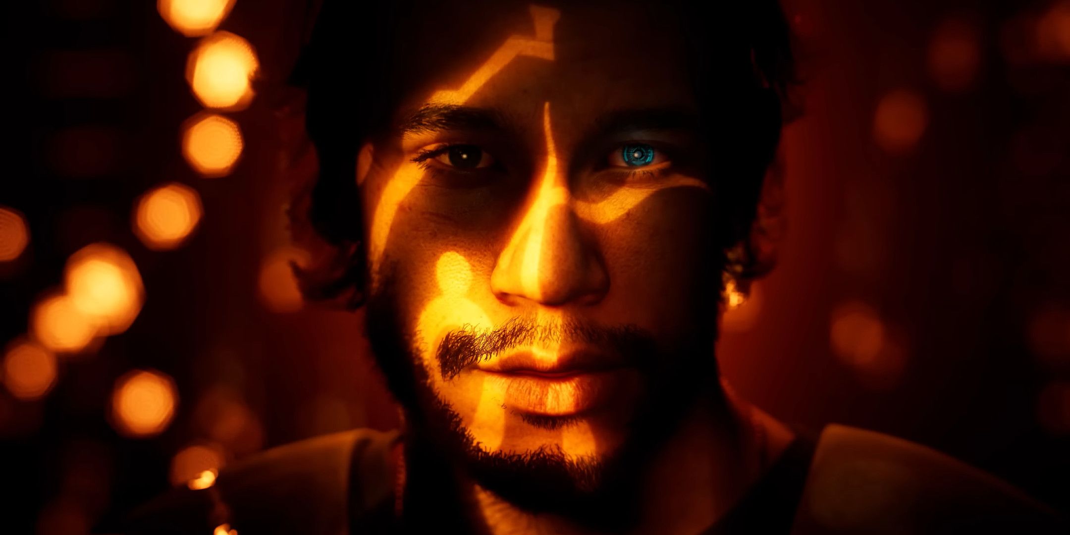 A close up of a man bathed in orange light