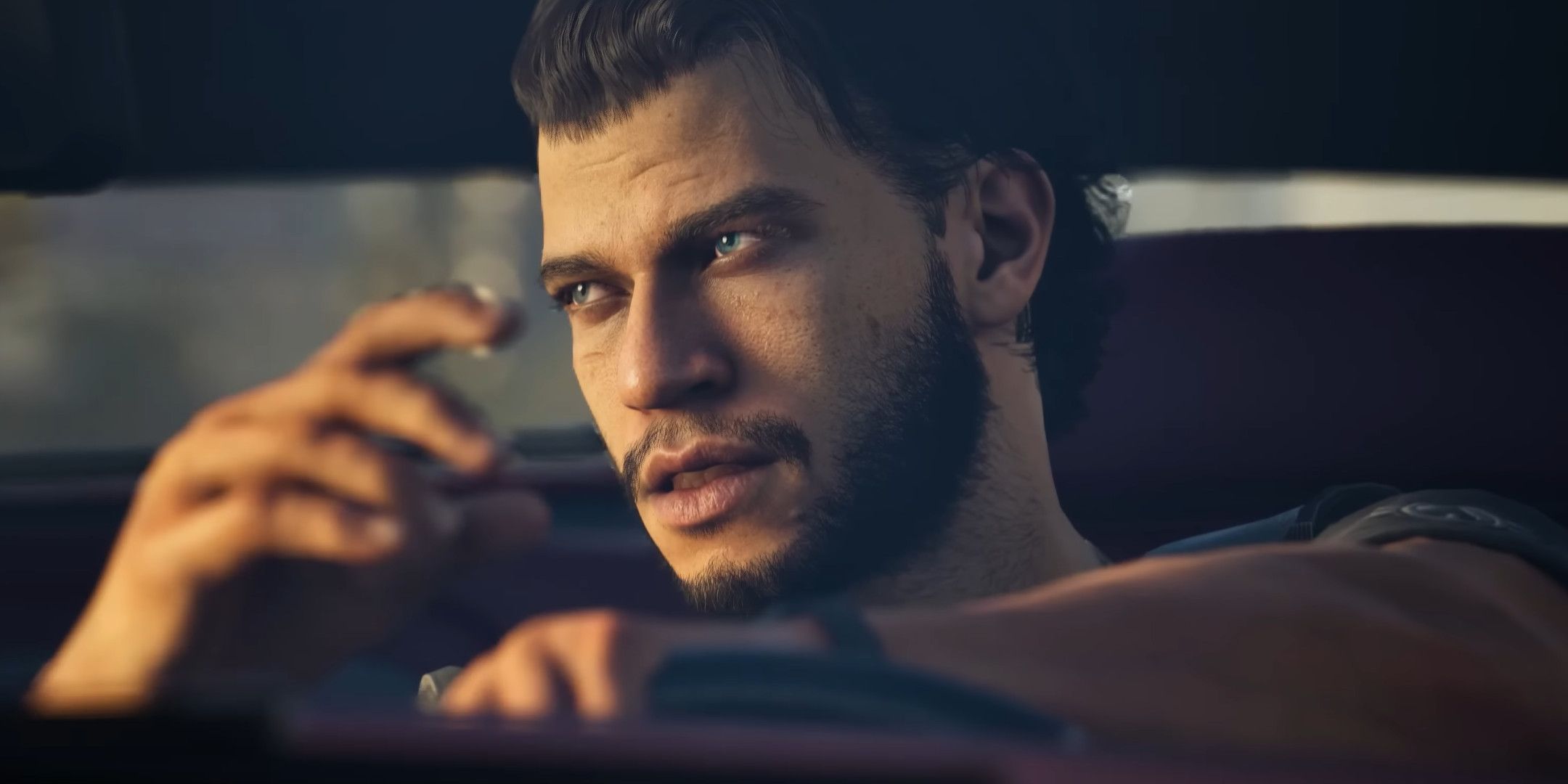 A close up of a man behind the wheel of a car