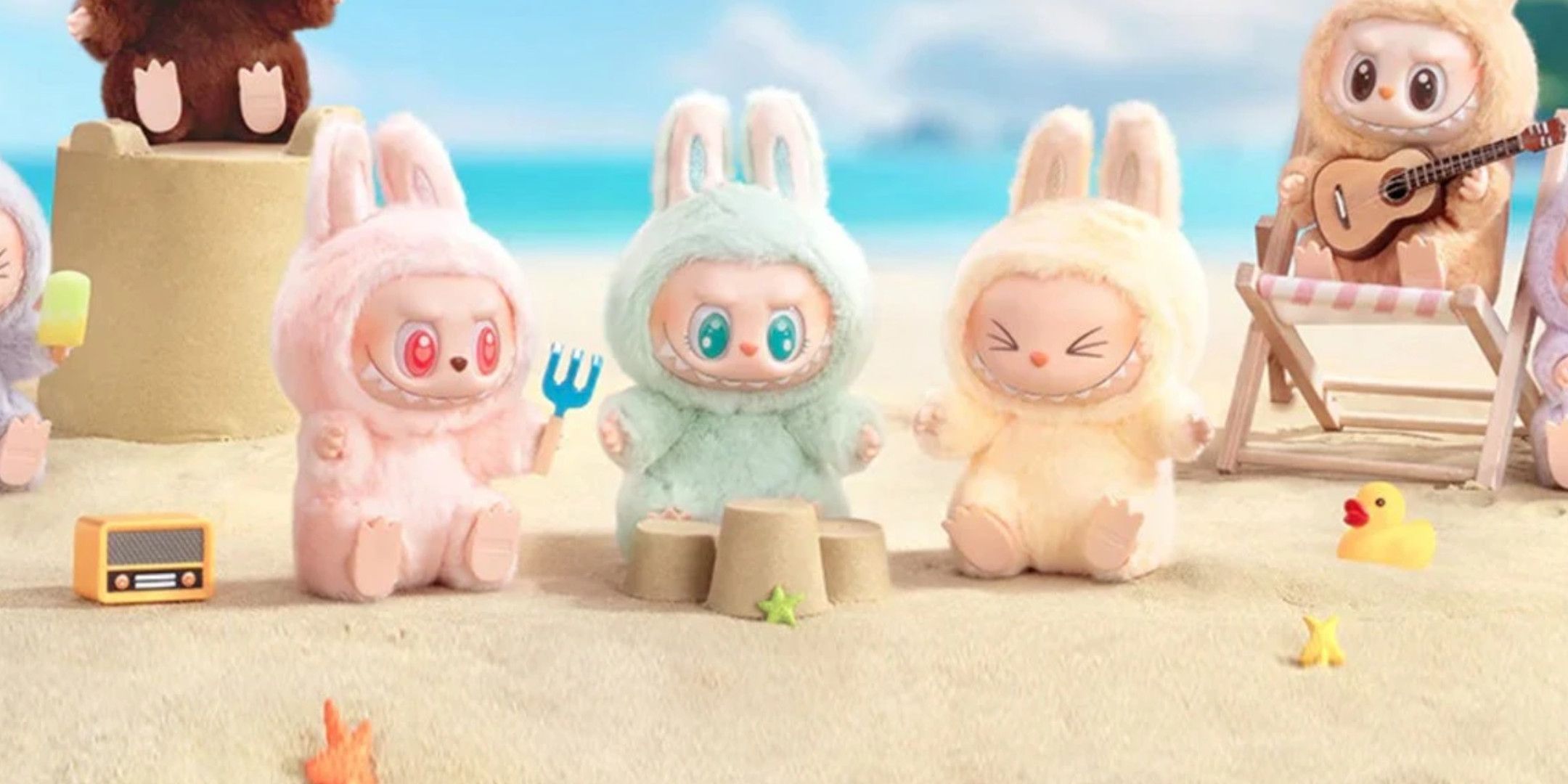 A group of Lububu sat playing on a beach