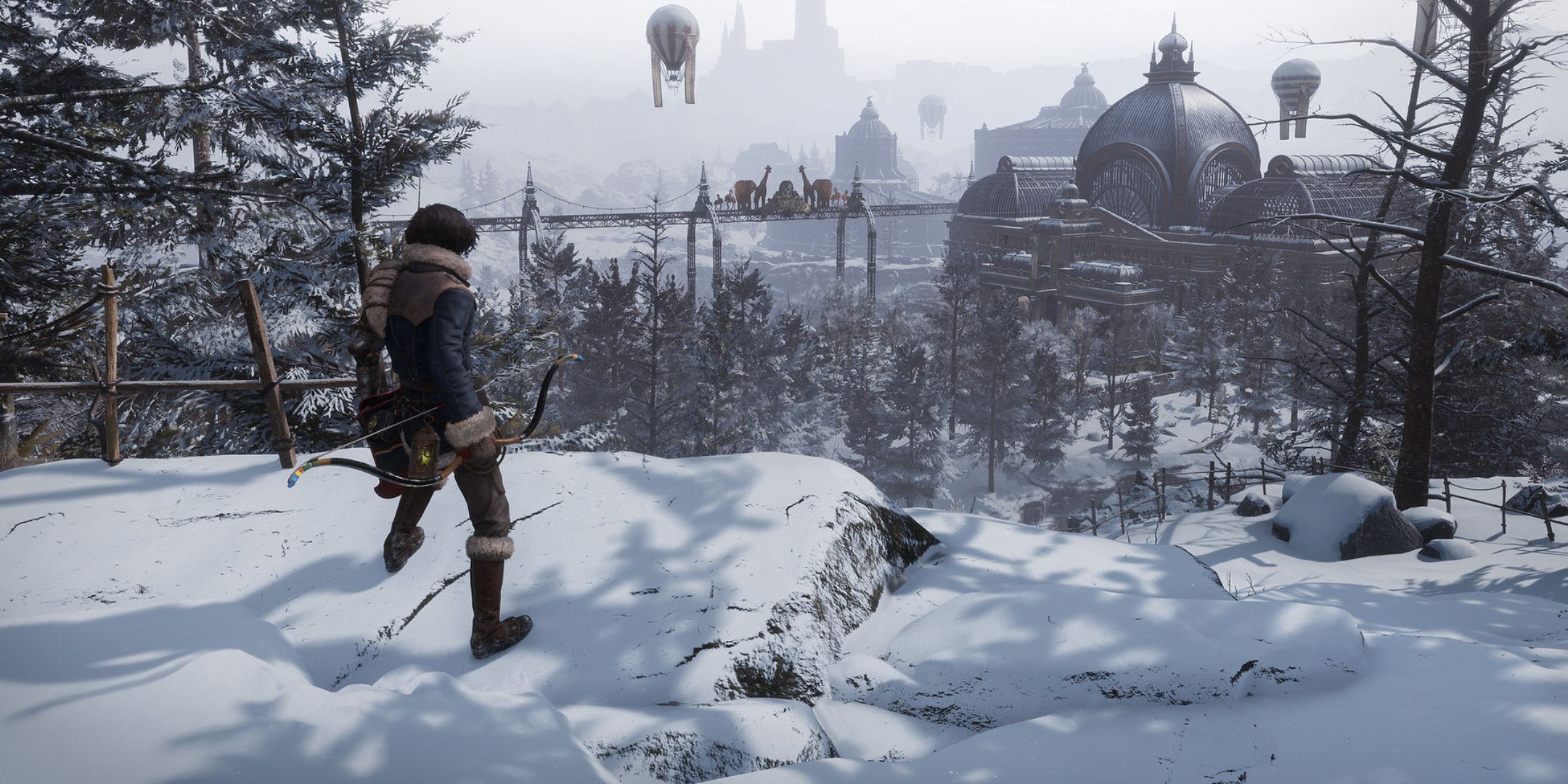 A man on a snowy cliff overlooking a tram station.