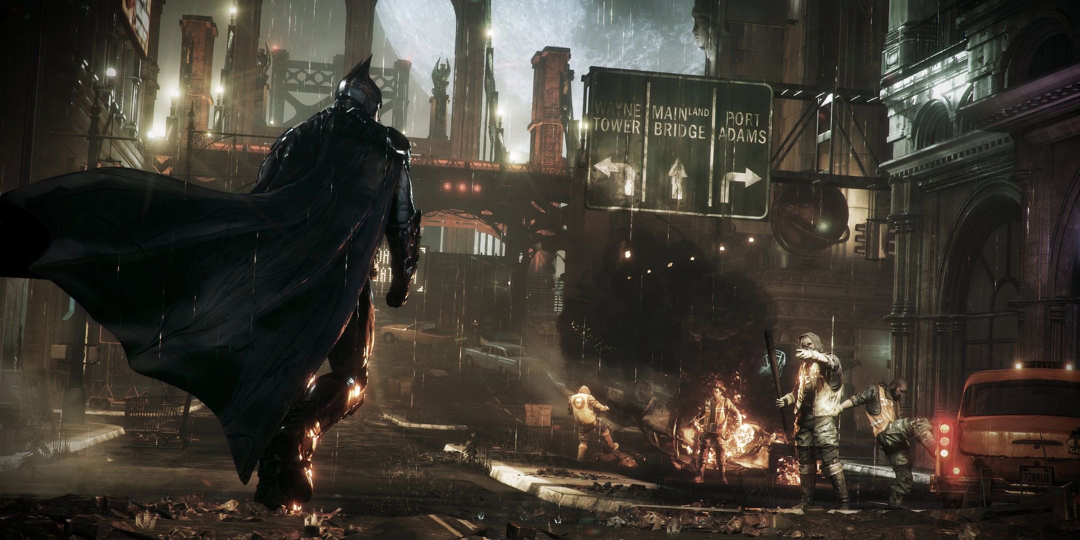 Batman walking through a burning Gotham in Batman: Arkham Knight.