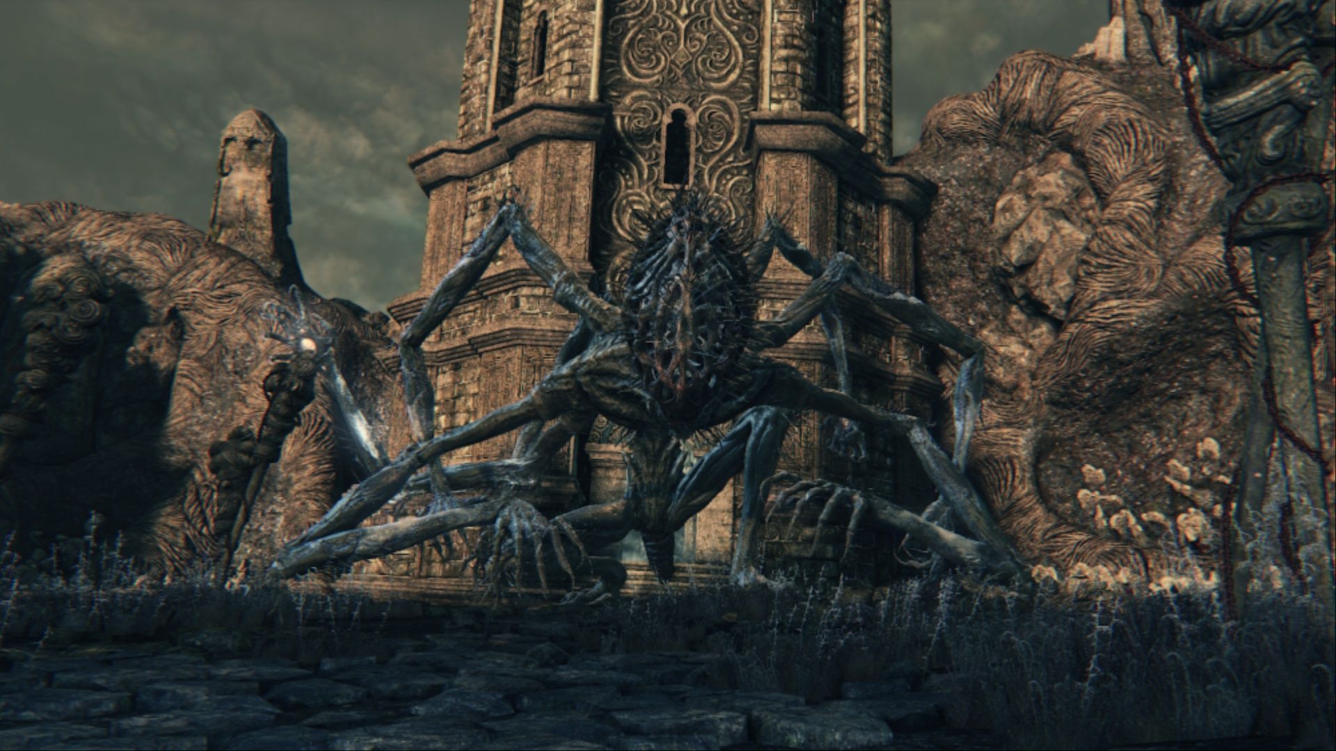 Amygdala standing in front of a large tower within the Nightmare Frontier in Bloodborne.