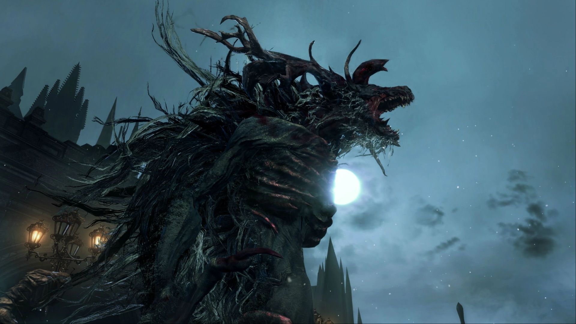 The Cleric Beast roaring atop a bridge while overlooking the streets of Yharnam in Bloodborn.