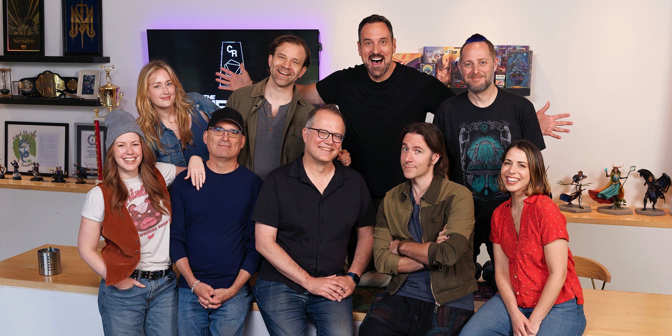 Chris Perkins and Jeremy Crawford in a photo with the cast of Critical Role. 