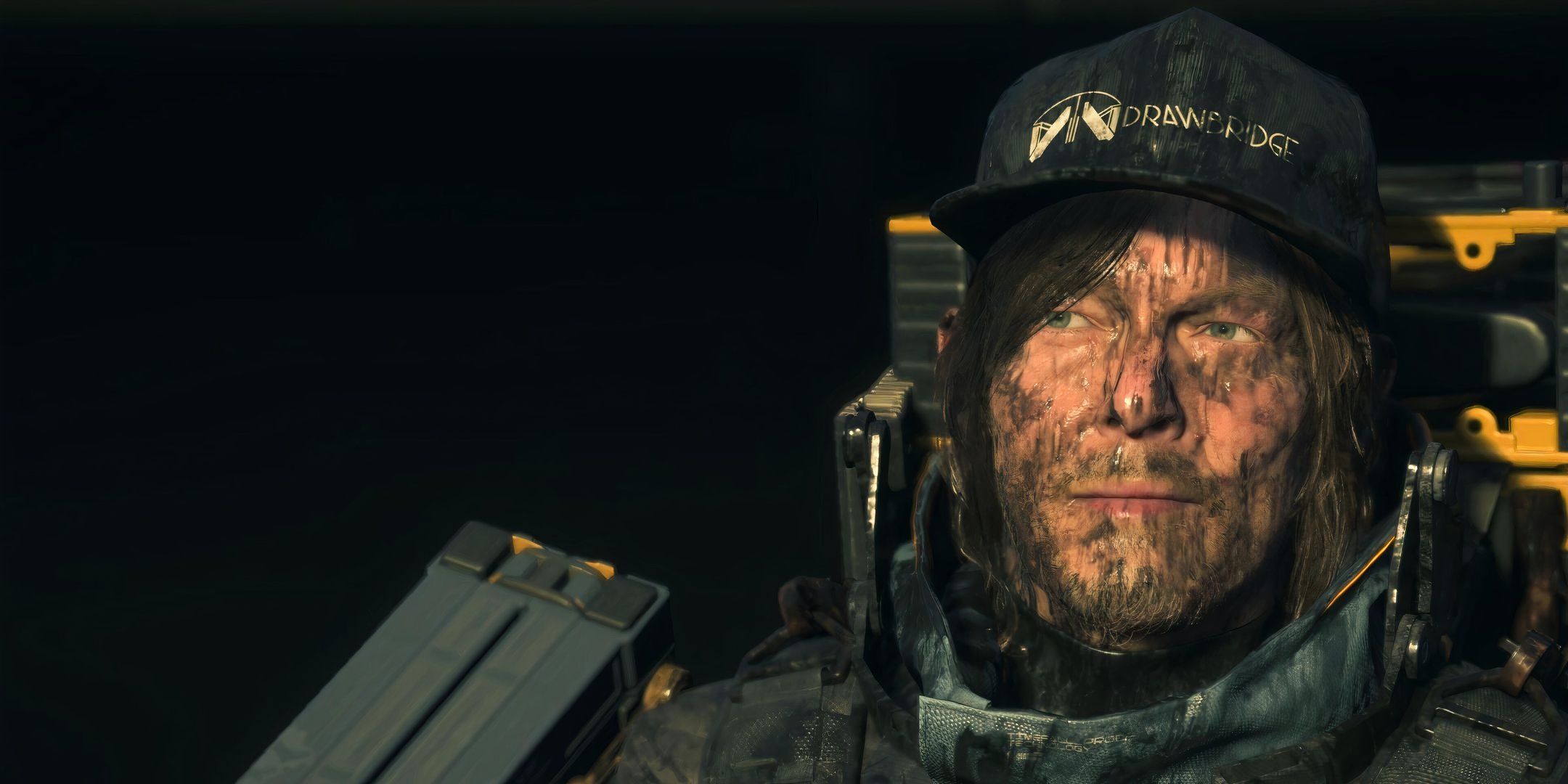 Sam covered in tar and looking annoyed in Death Stranding 2: On the Beach.