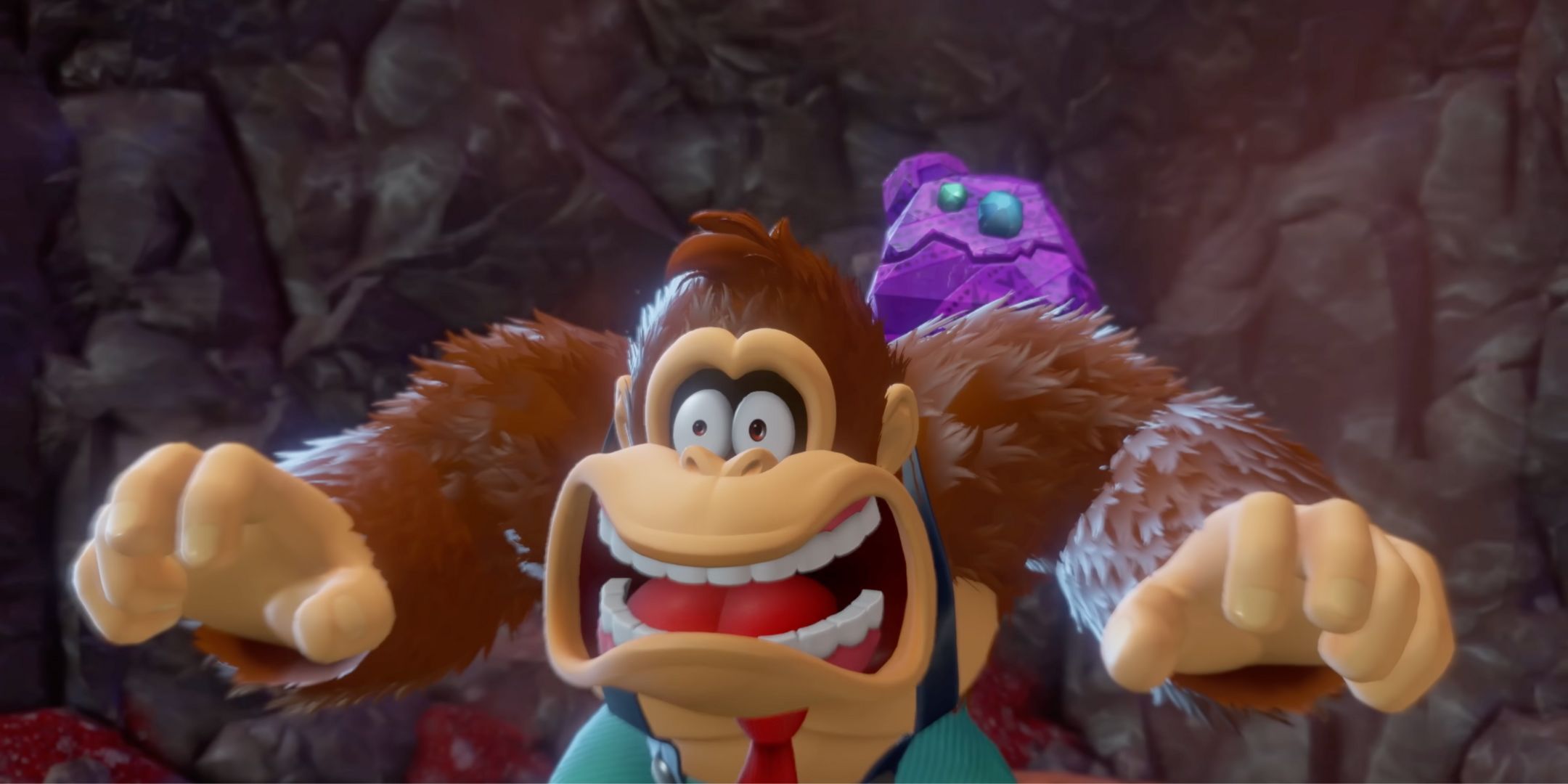 Donkey Kong looking shocked as Odd Rock lands on him in Donkey Kong Bananza.