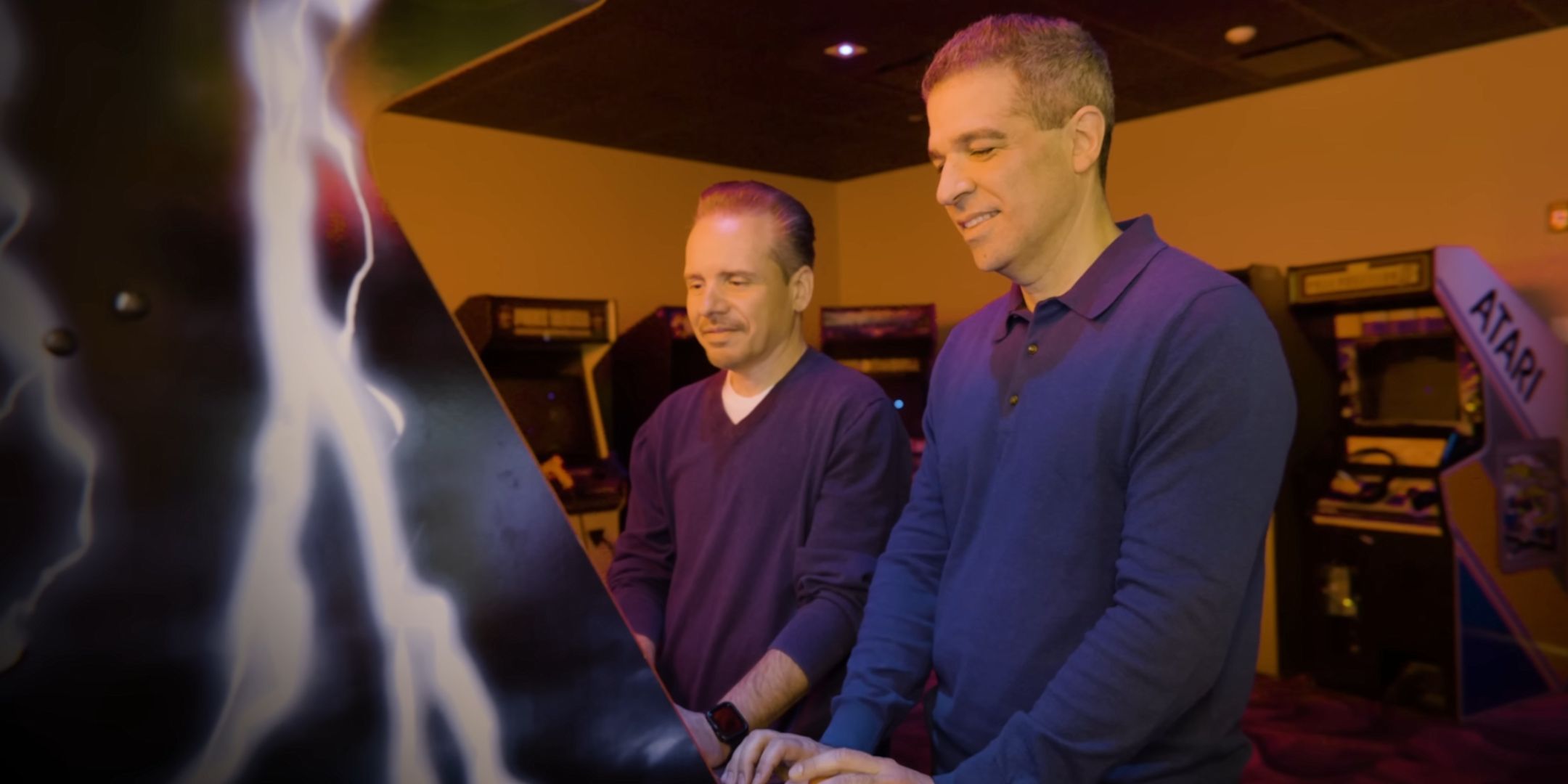 John Tobias and Ed Boon playing Mortal Kombat on an arcade machine