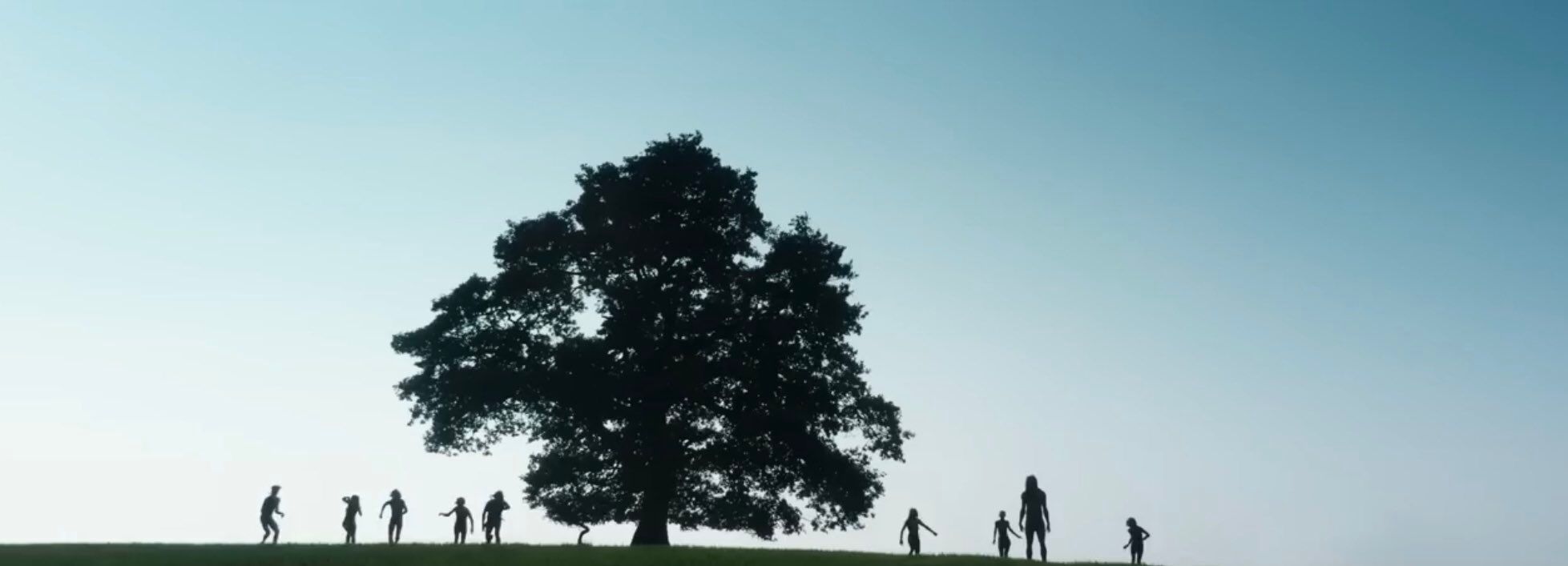 Infected stand atop a hill next to a tree in 28 Years Later. 