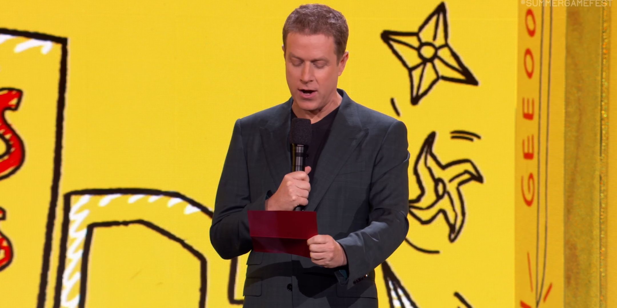 Geoff Keighley reading from a letter on the stage of Summer Game Fest