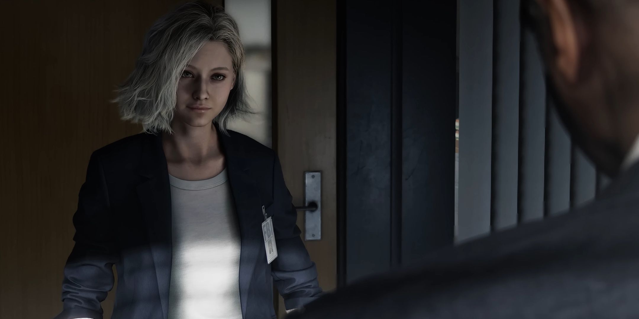 Grace Ashcroft speaking to another FBI agent in Resident Evil 9, who has his back turned.