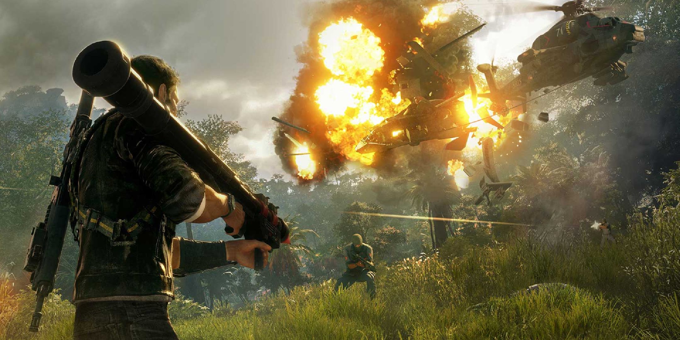 Just Cause 4 Rico holding a rocket launcher and watching as a helicopter explodes.