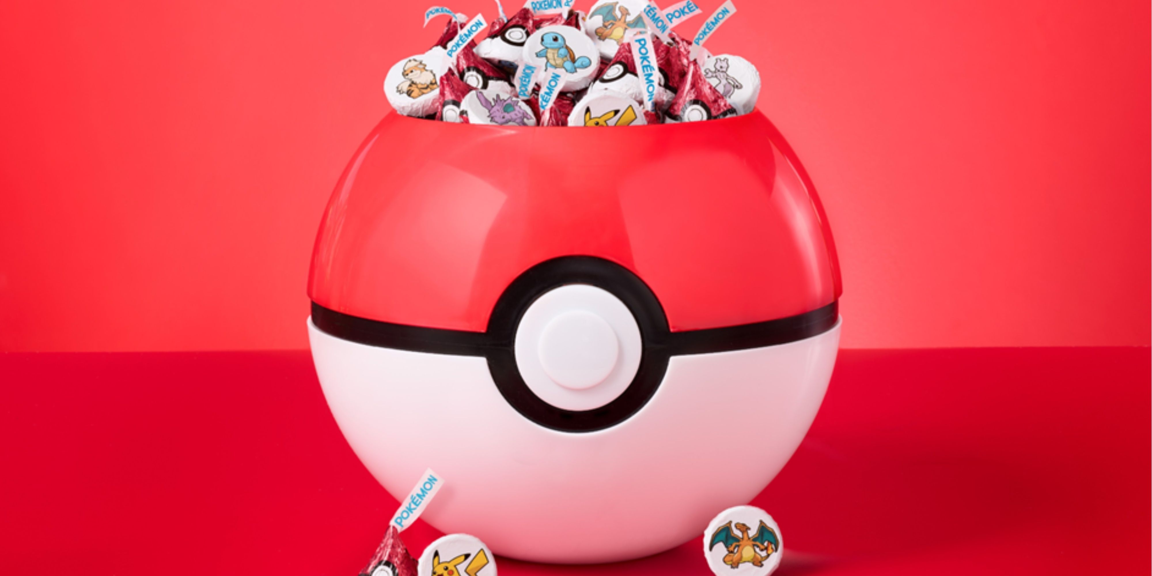 a pokeball filled with collectible pokemon hershey's kisses.