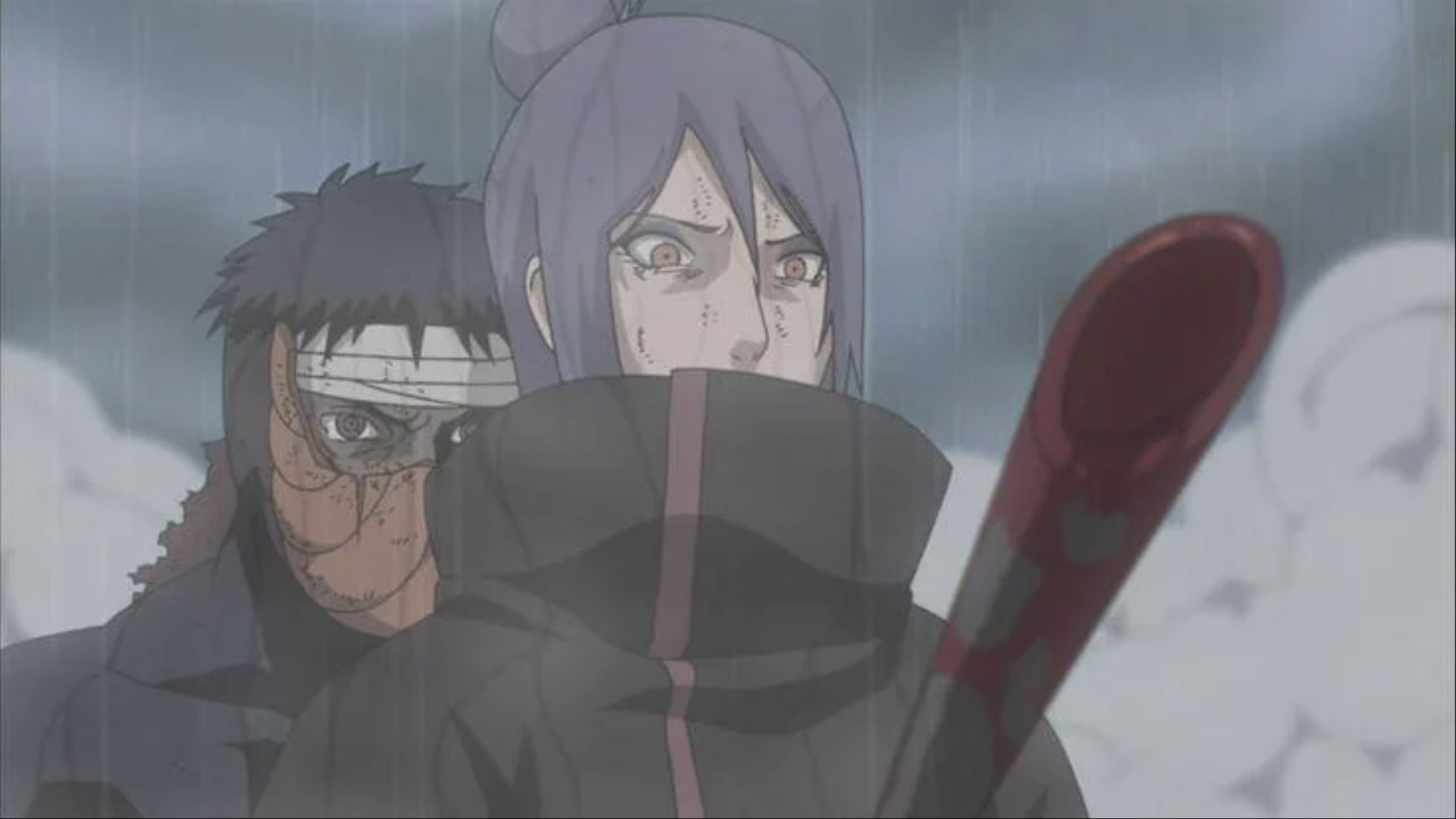 Tobi stabbing Konan through the chest, delivering a killing blow, in Naruto: Shippuden.
