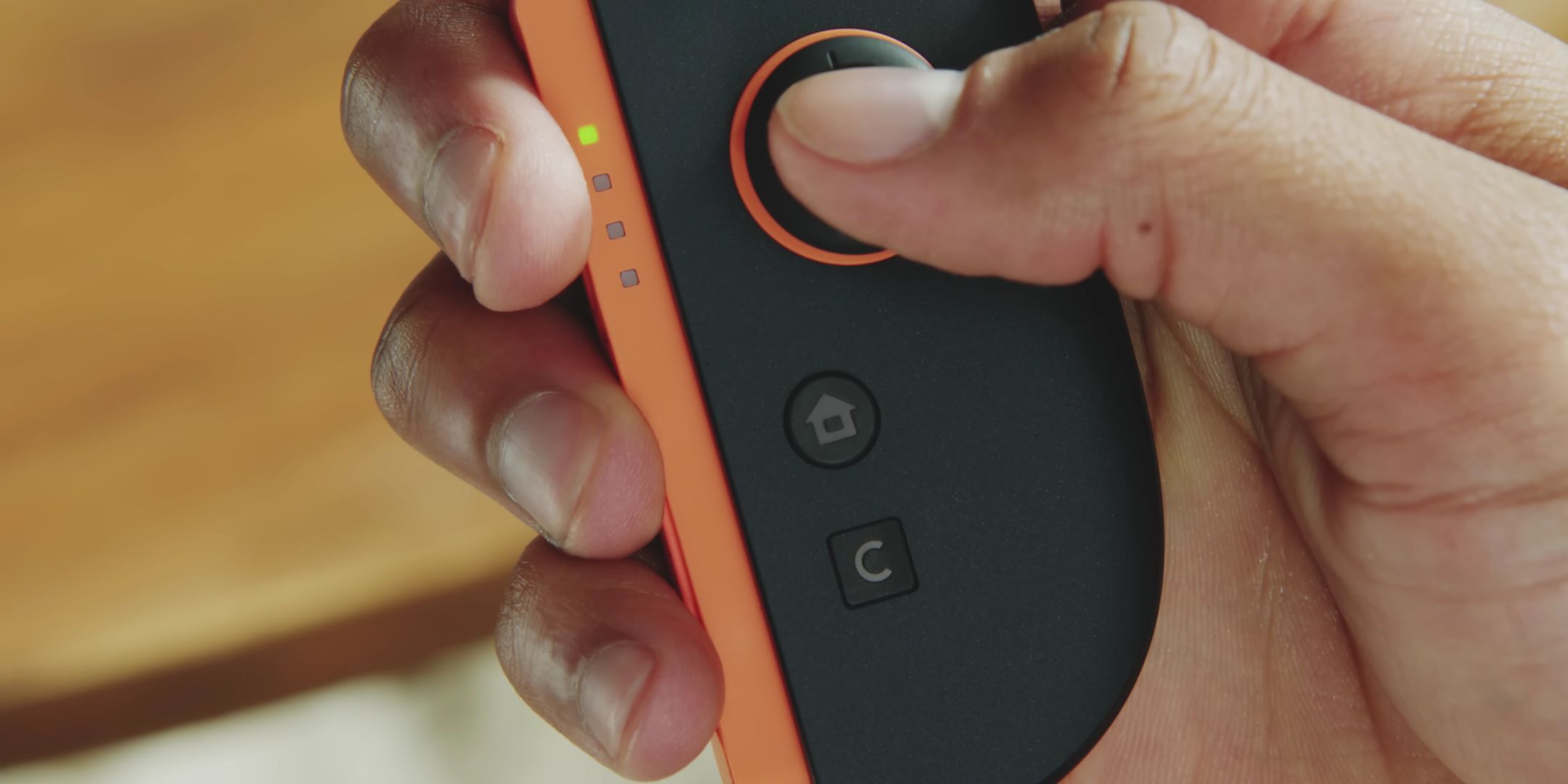 Someone about to press the Switch 2's C Button for GameChat.