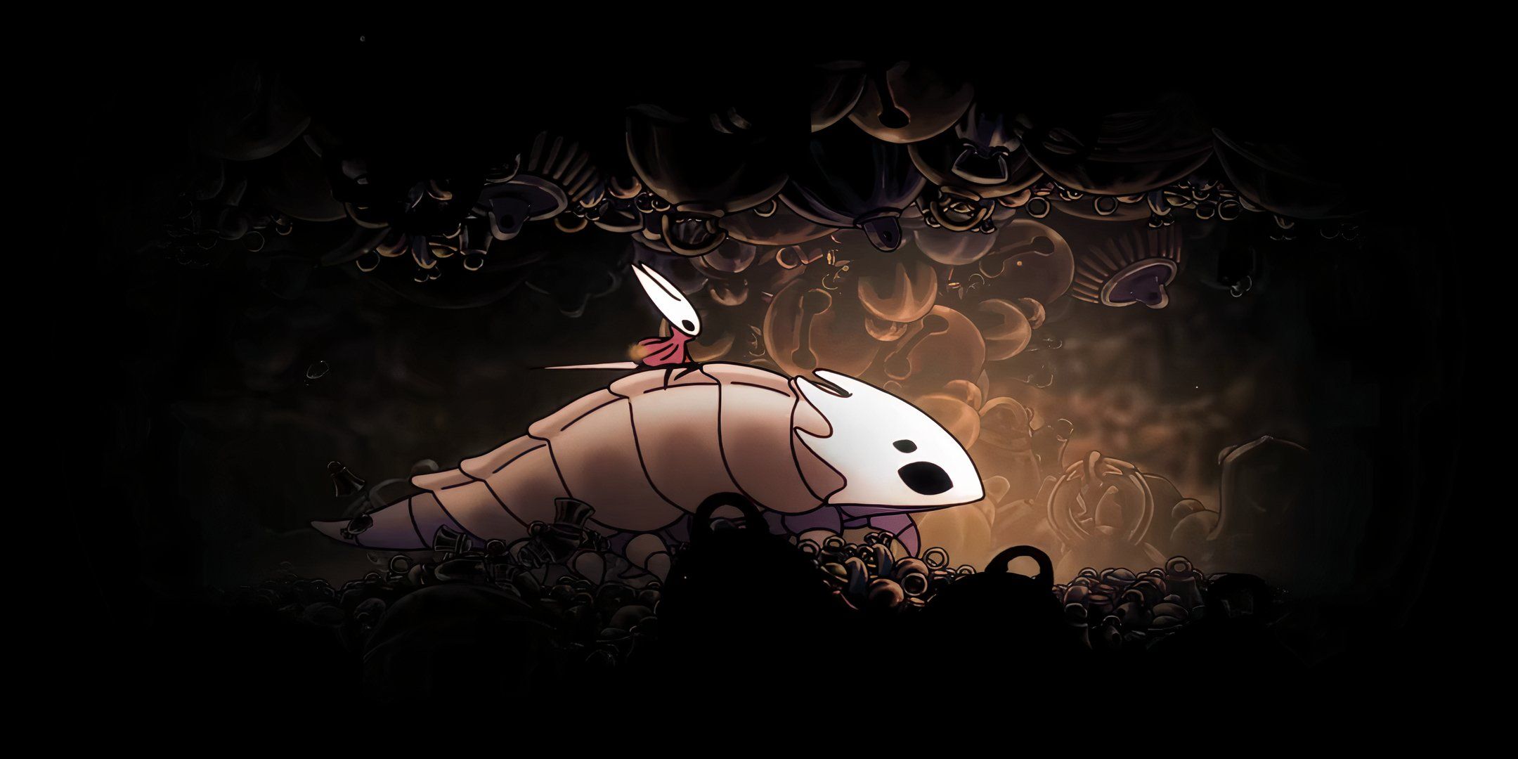 silksong riding a creature through the underground.