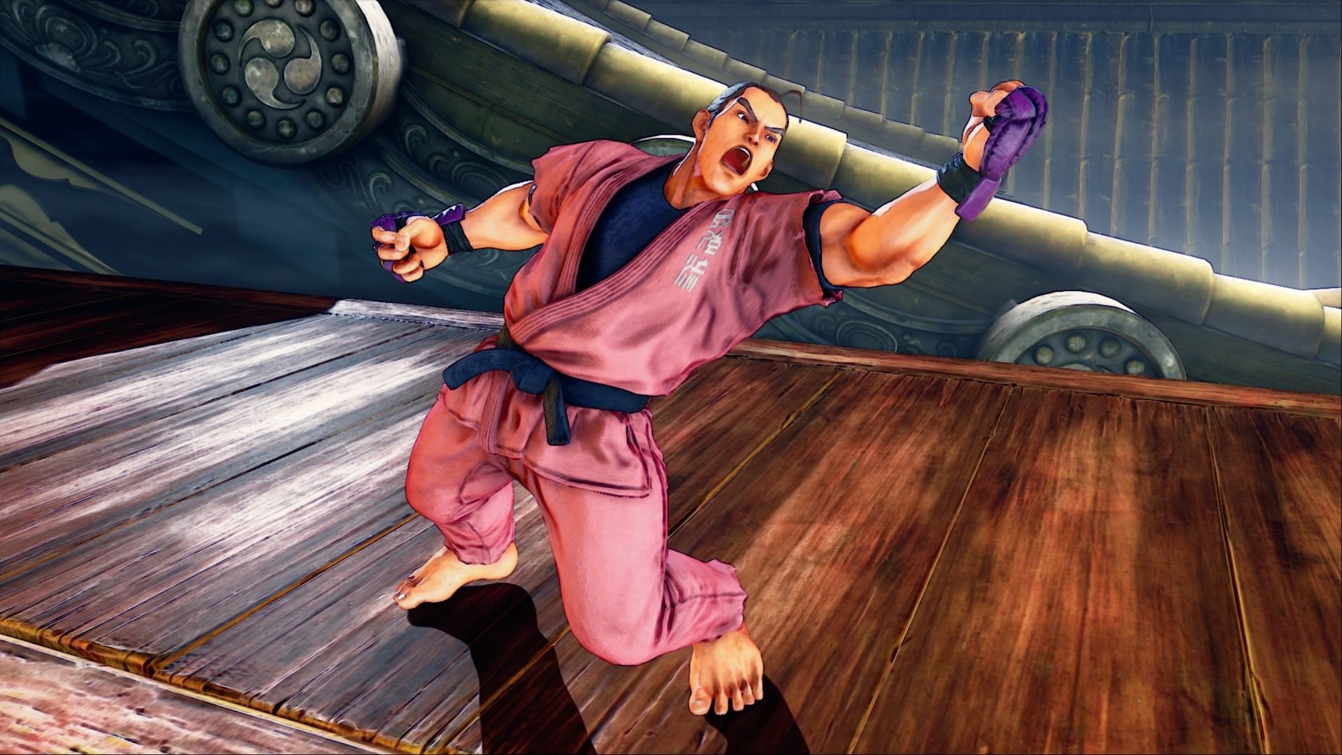 Dan raising his fist in the air in victory in Street Fighter V.