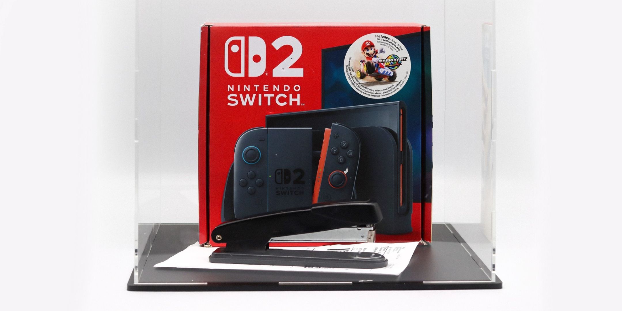 A stapler and a Nintendo Switch 2 in a display case