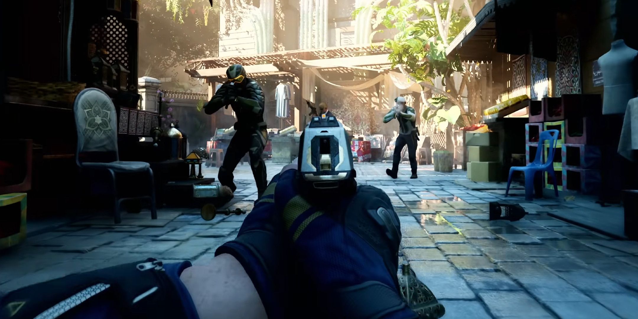 First person view of someone aiming down the sights of a pistol at three armed men.
