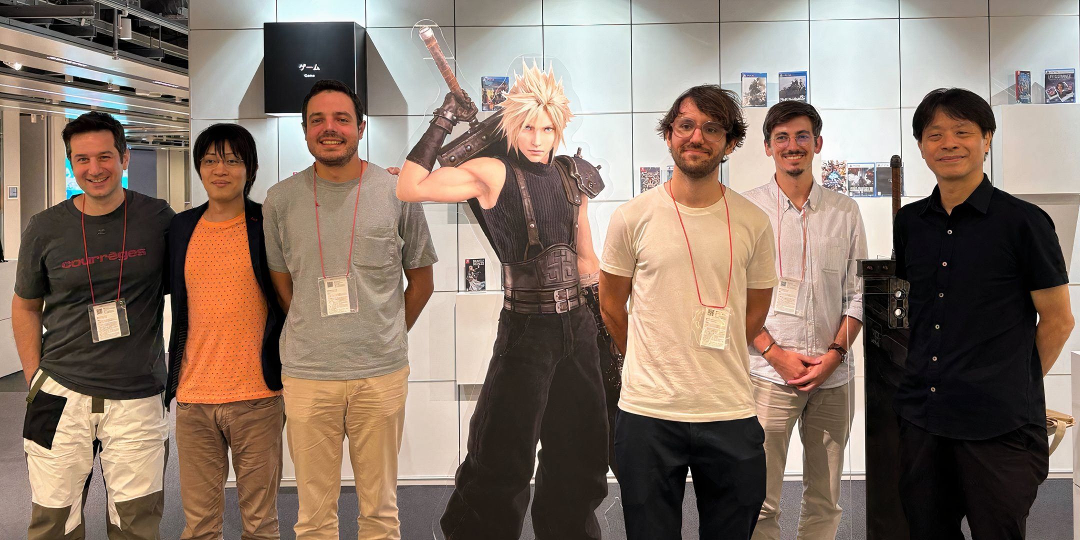 Hamaguchi, Kitase, and several Sandfall Interactive developers stand together for a photo.