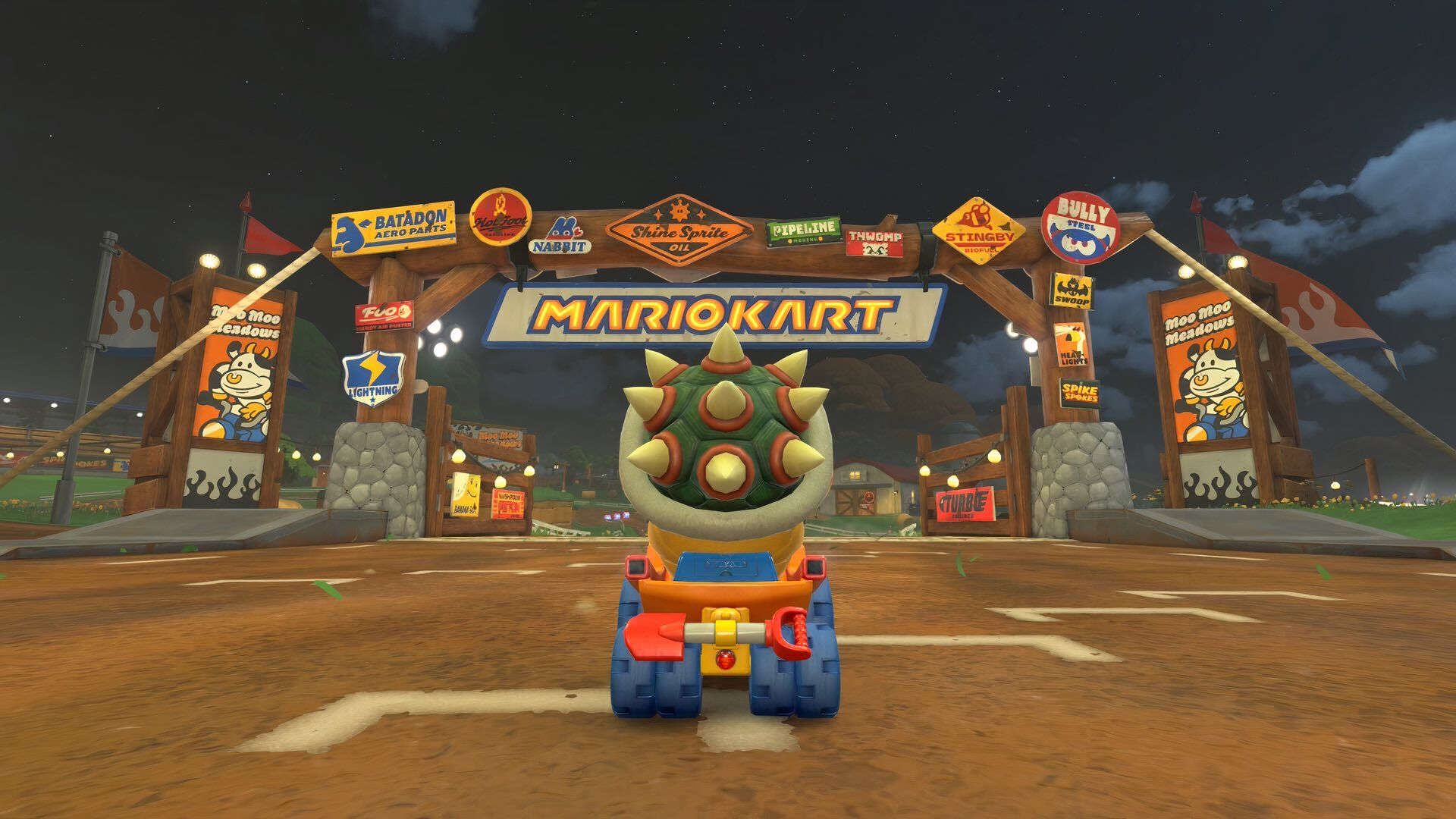 Bowser at the start line of a race which is covered in adverts.