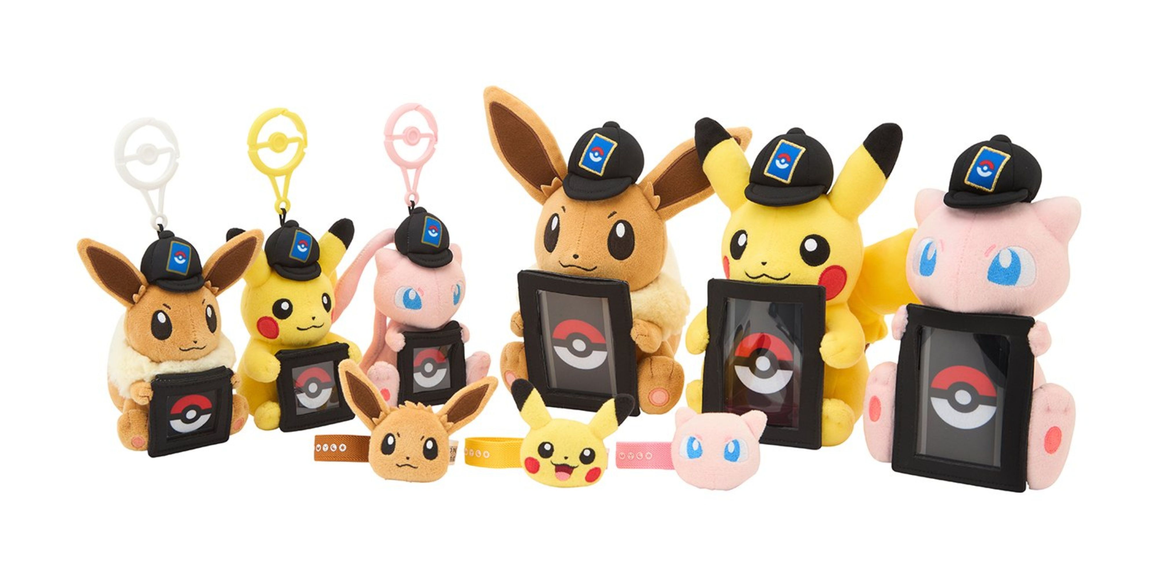 pokemon tcg card, coin, and accessory holding plushes.