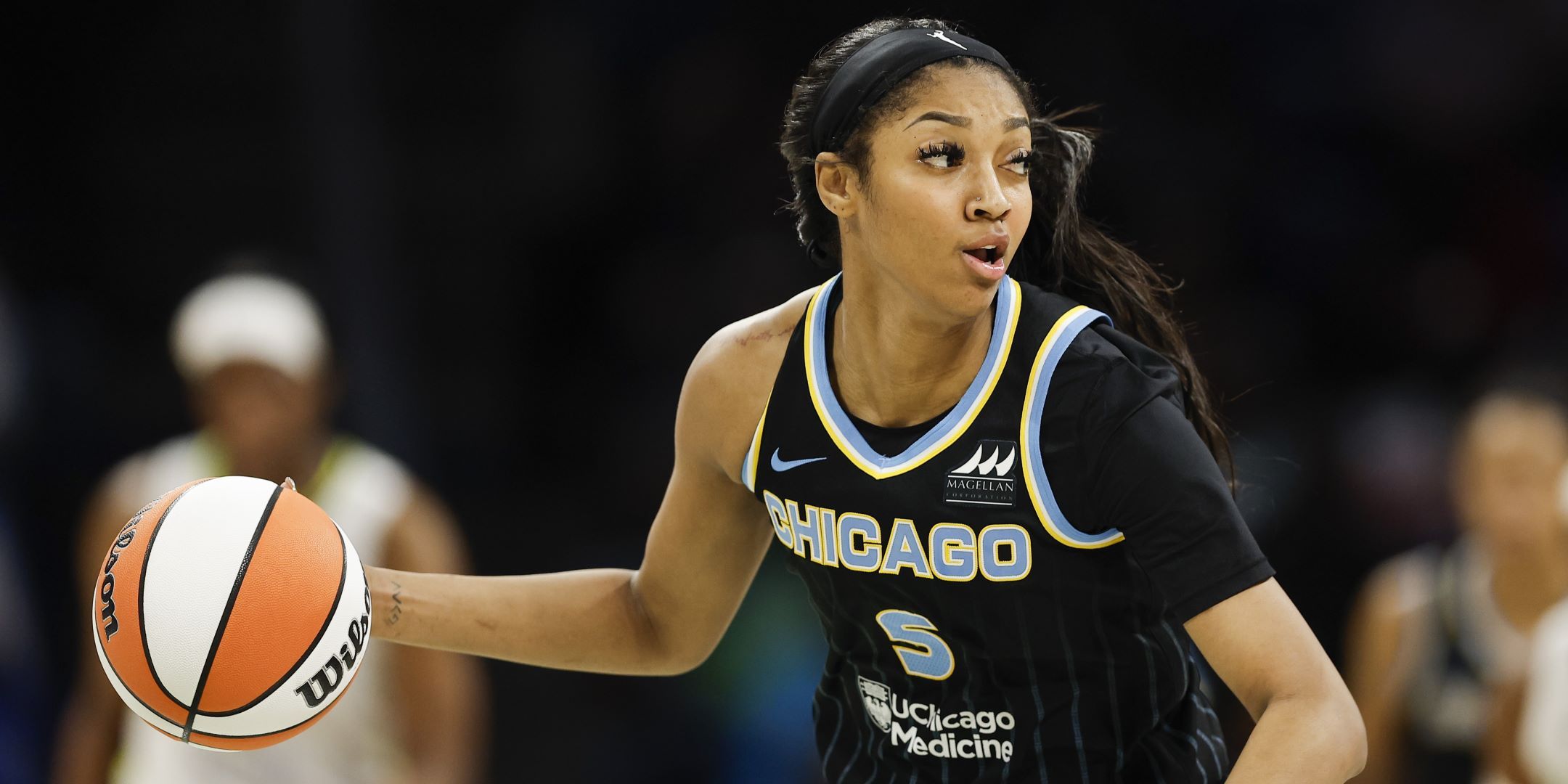 Angel Reese dribbling a basketball in the Chicago Sky uniform
