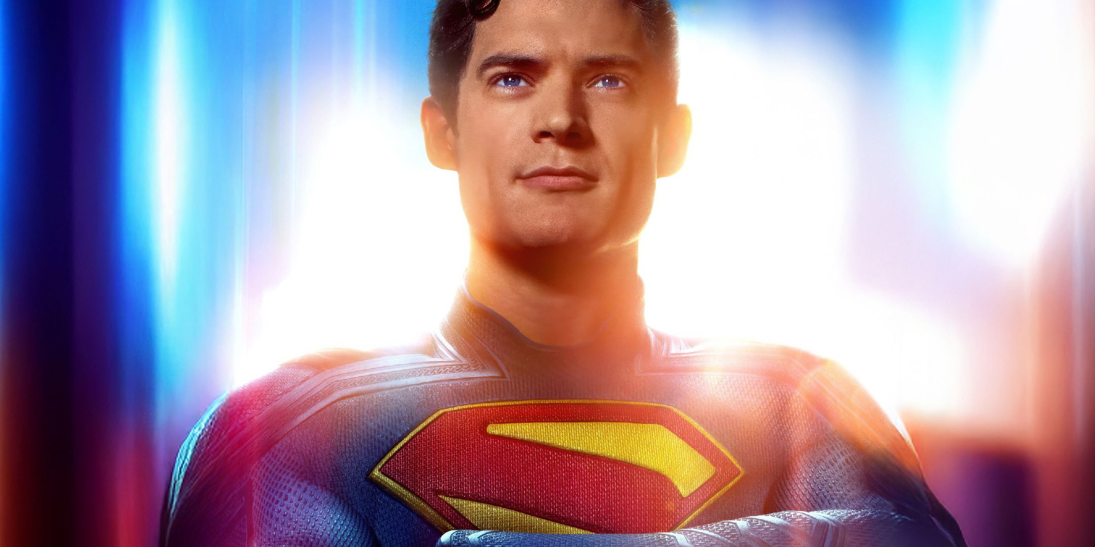 Superman standing with his arms crossed, smiling.
