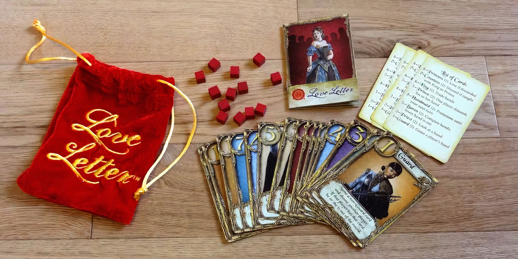 A spread of the components of the Love Letter board game.