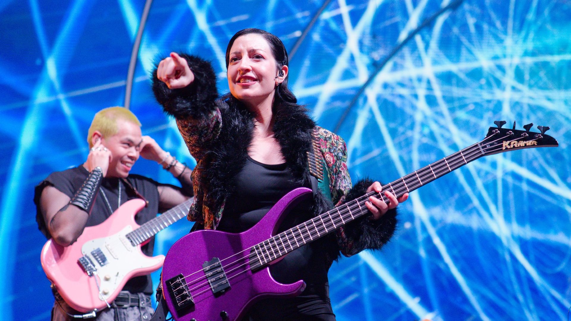 Warframe's creative director Rebecca Ford playing the bass in the Tennoconcert 2025.
