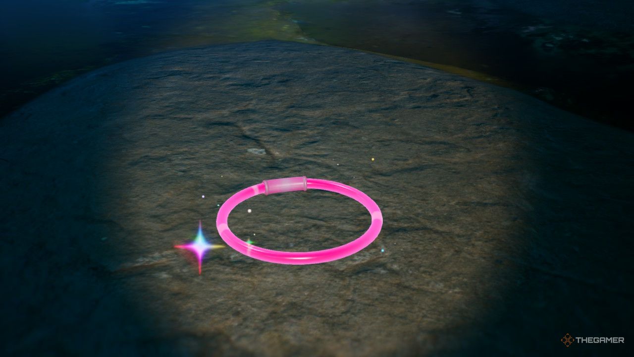 a red glow bracelet near water
