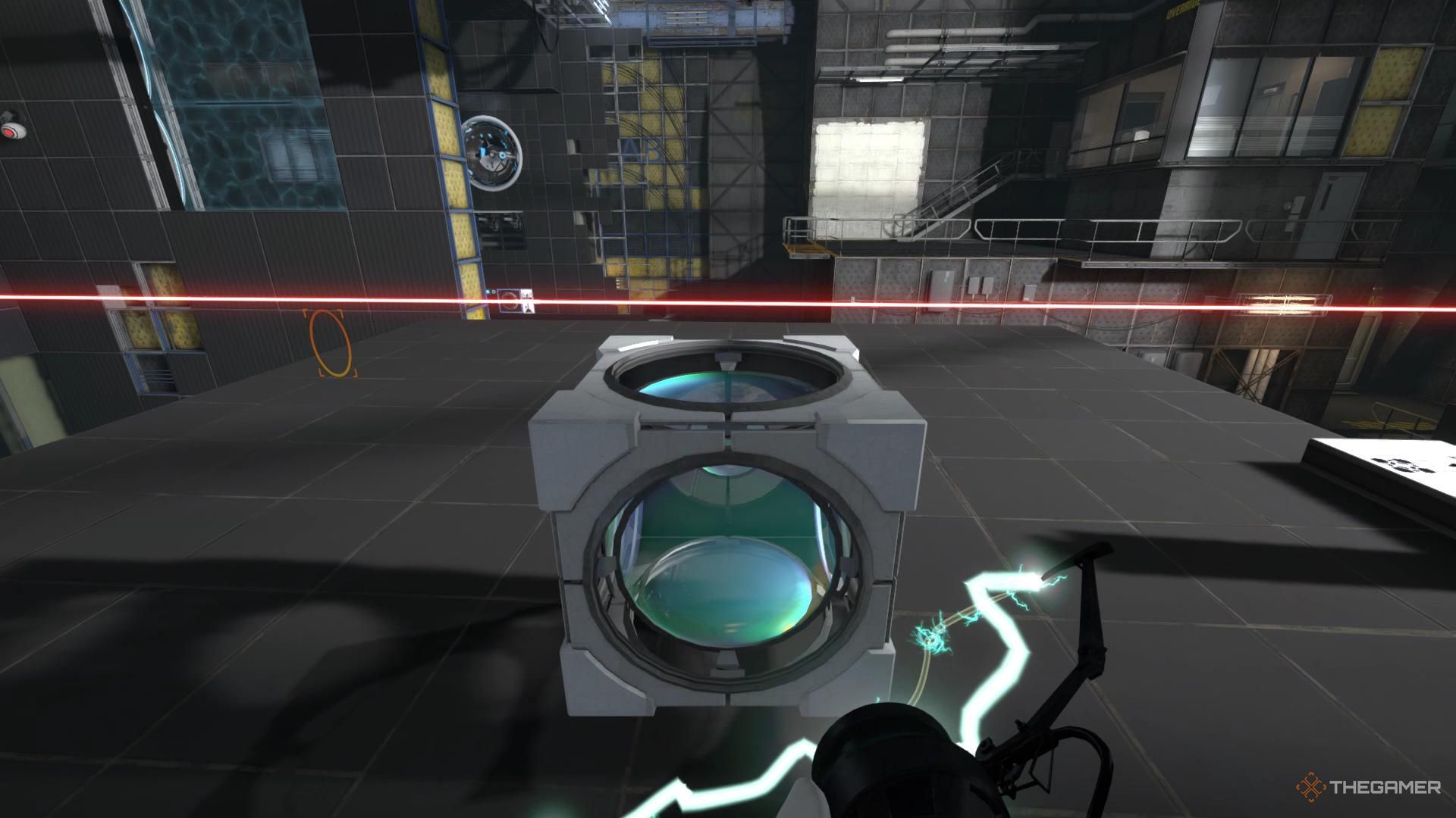 A screenshot from Portal Revolution showing the player character holding a prism cube near a laser, with the orange portal seen lower in the distance