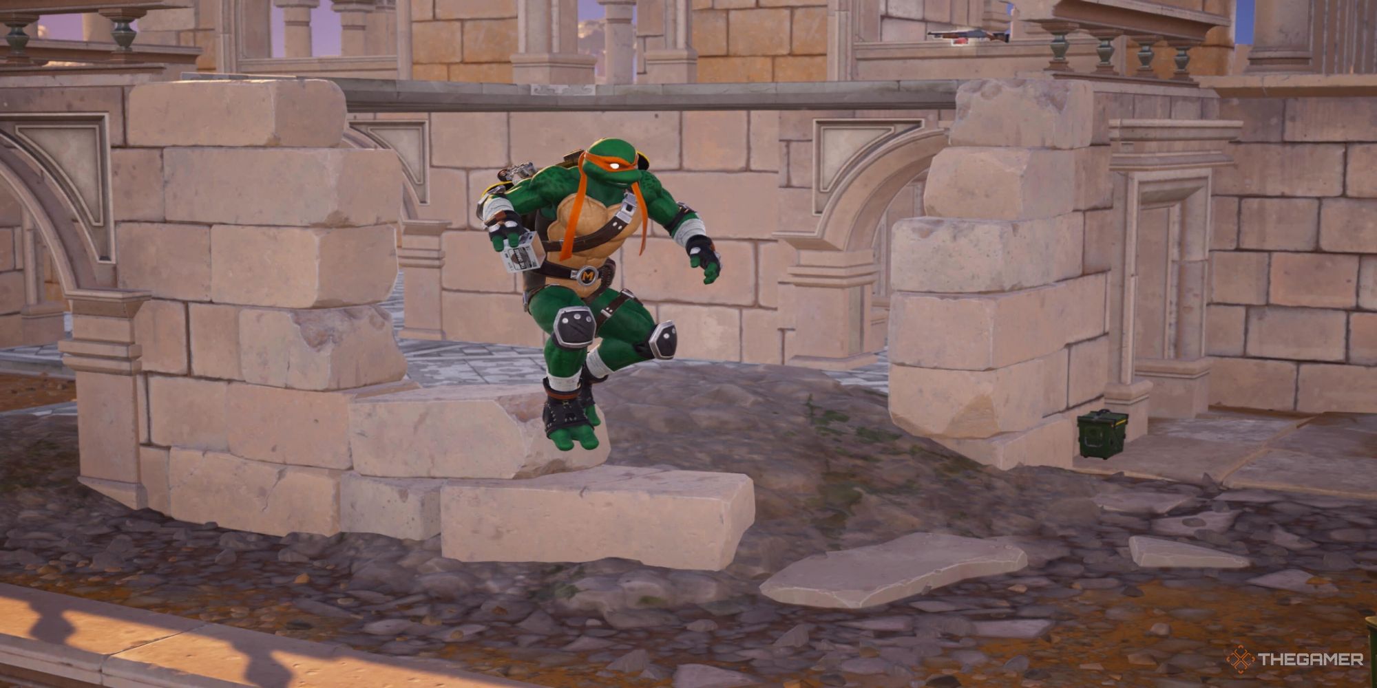A screenshot from Fortnite showing Michaelangelo from TMNT jumping in front of ruins made out of white brick. He's holding a deployable Cardboard Box in his hand